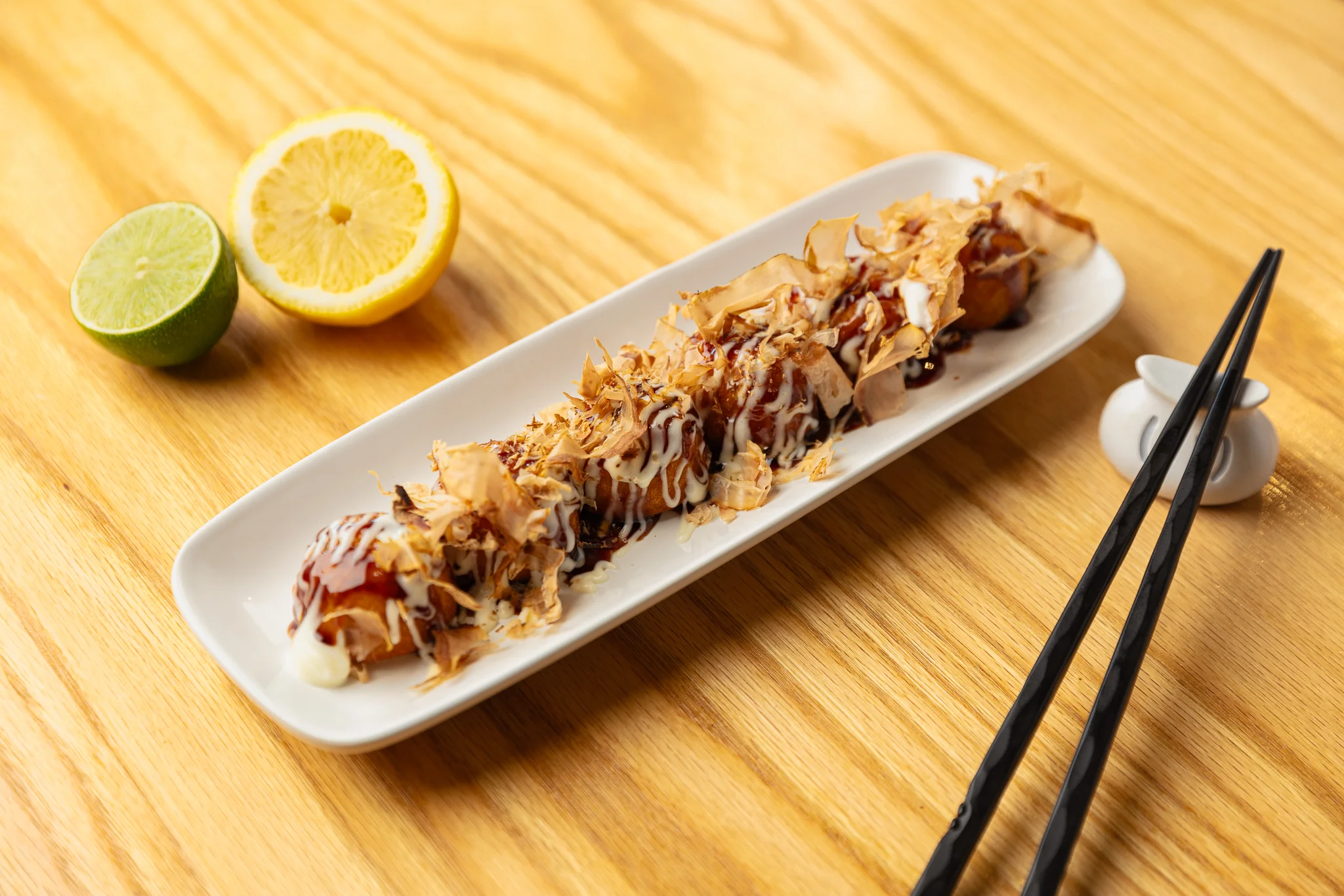 Japanese takoyaki drizzled with sauce and bonito flakes