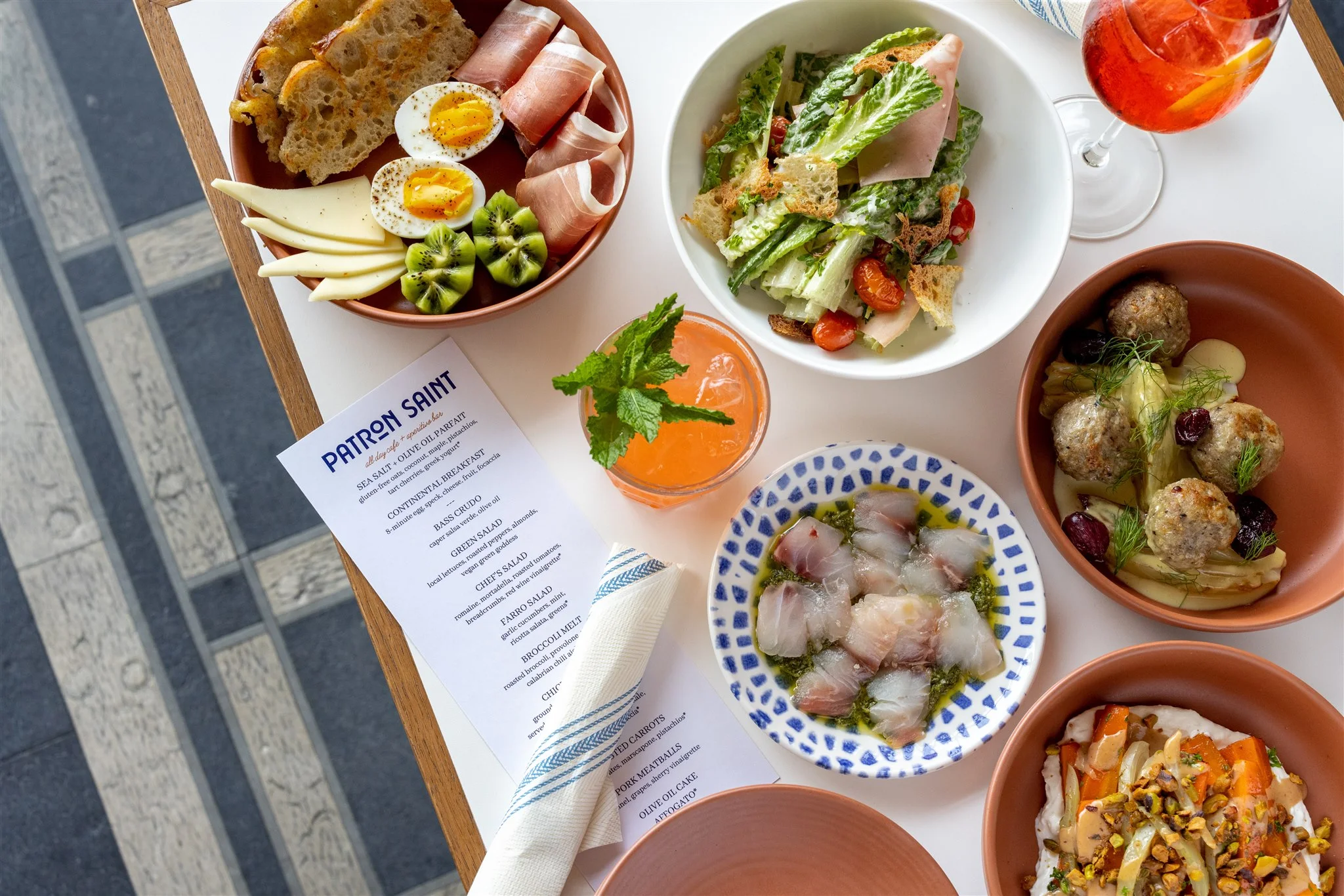 Assorted Mediterranean dishes with fresh salads and cocktails