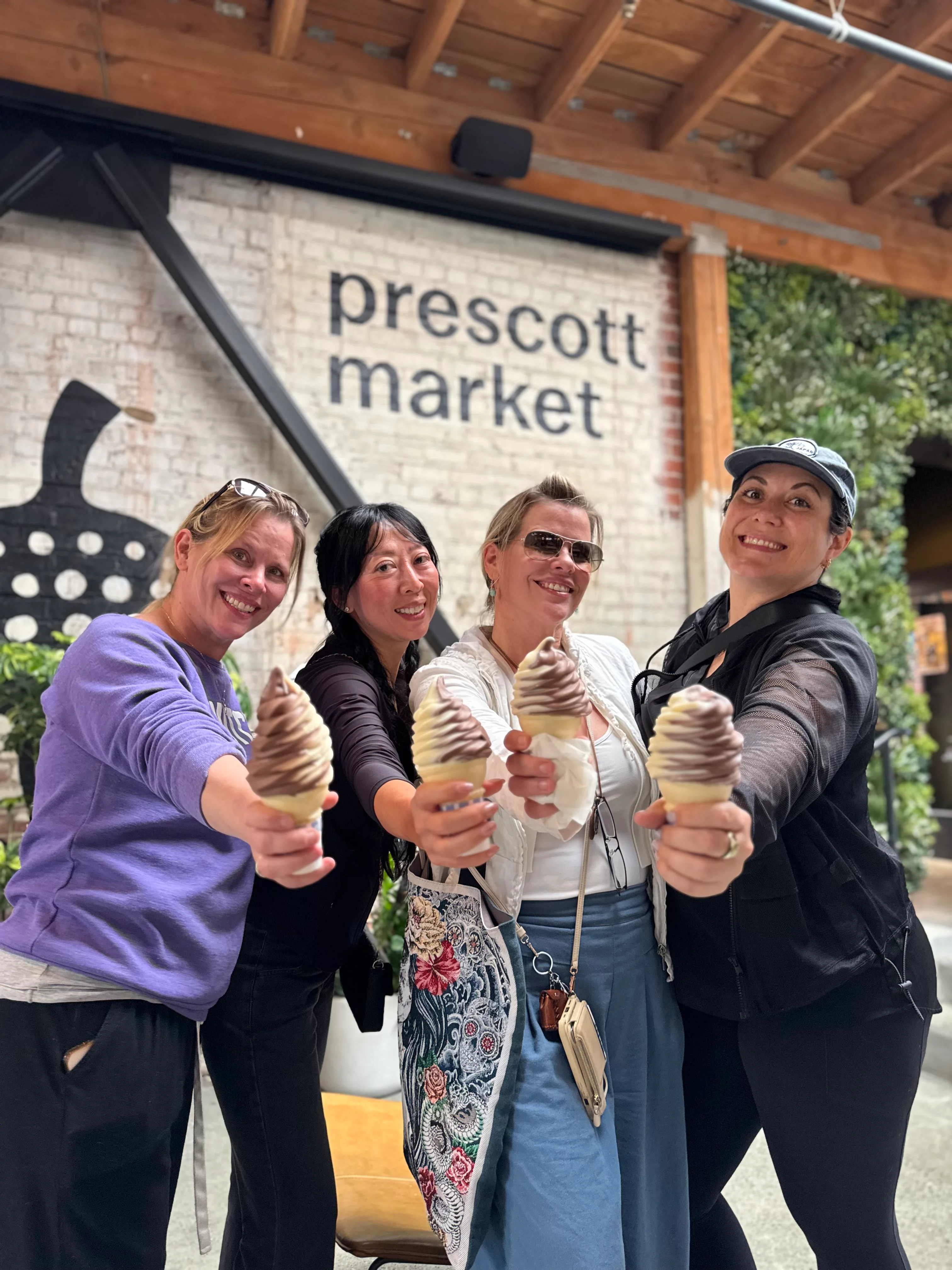 Group of friends enjoying soft serve ice cream cones at Prescott Market
