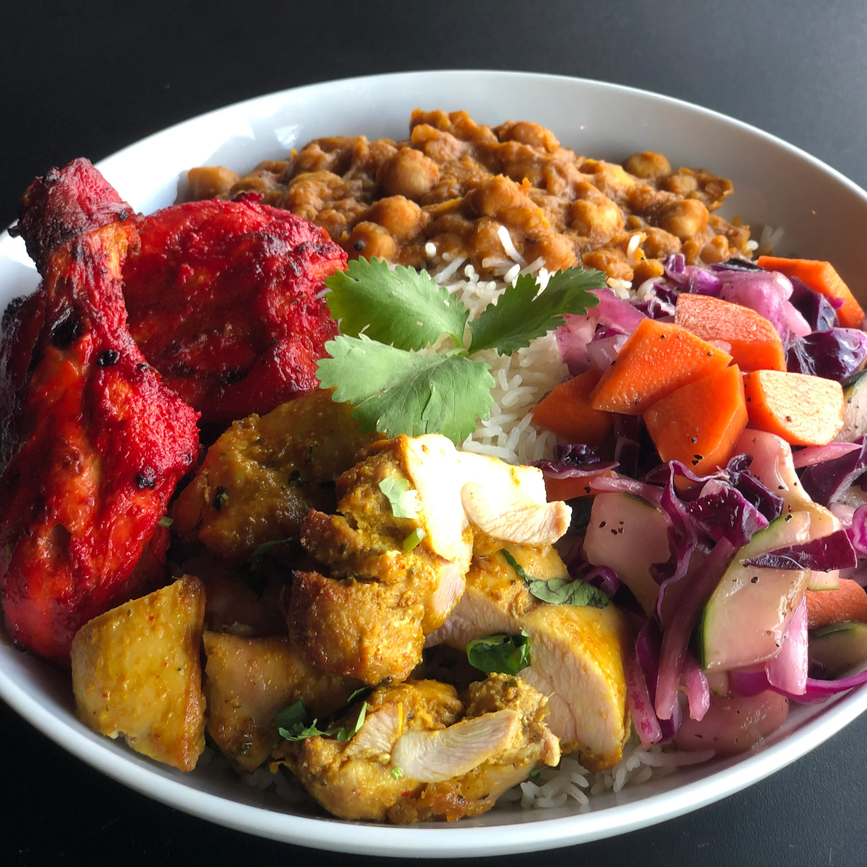 Indian tandoori chicken platter with rice and salad