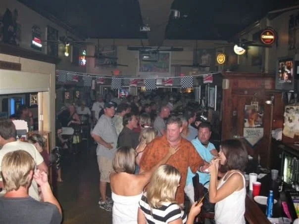 Group of friends enjoying drinks at a lively bar