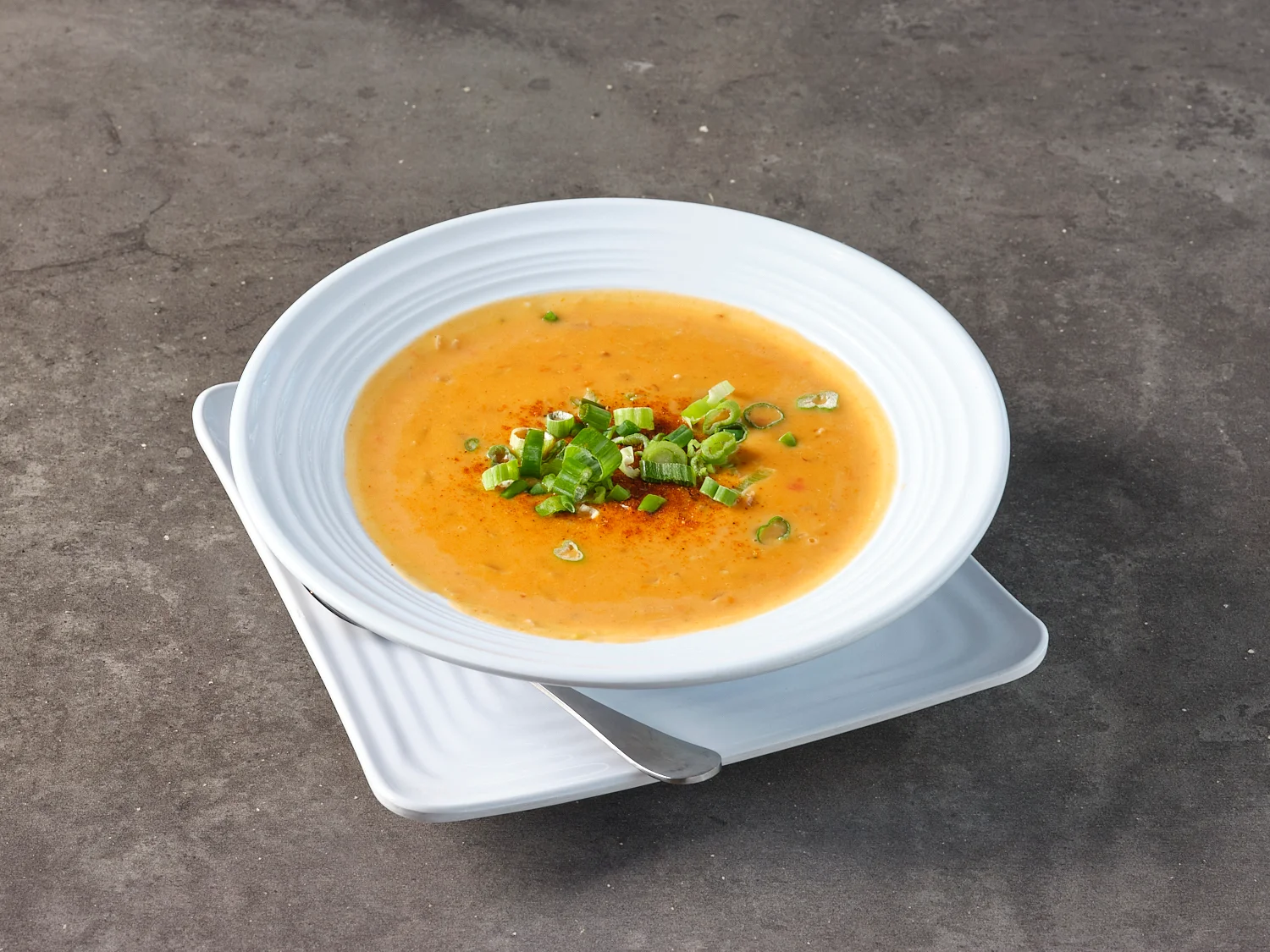 Creamy American corn chowder garnished with green onions