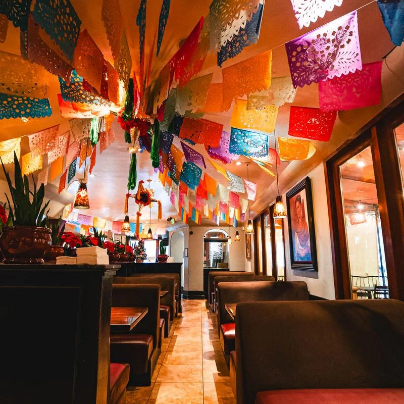 Vibrant restaurant interior with colorful papel picado decorations