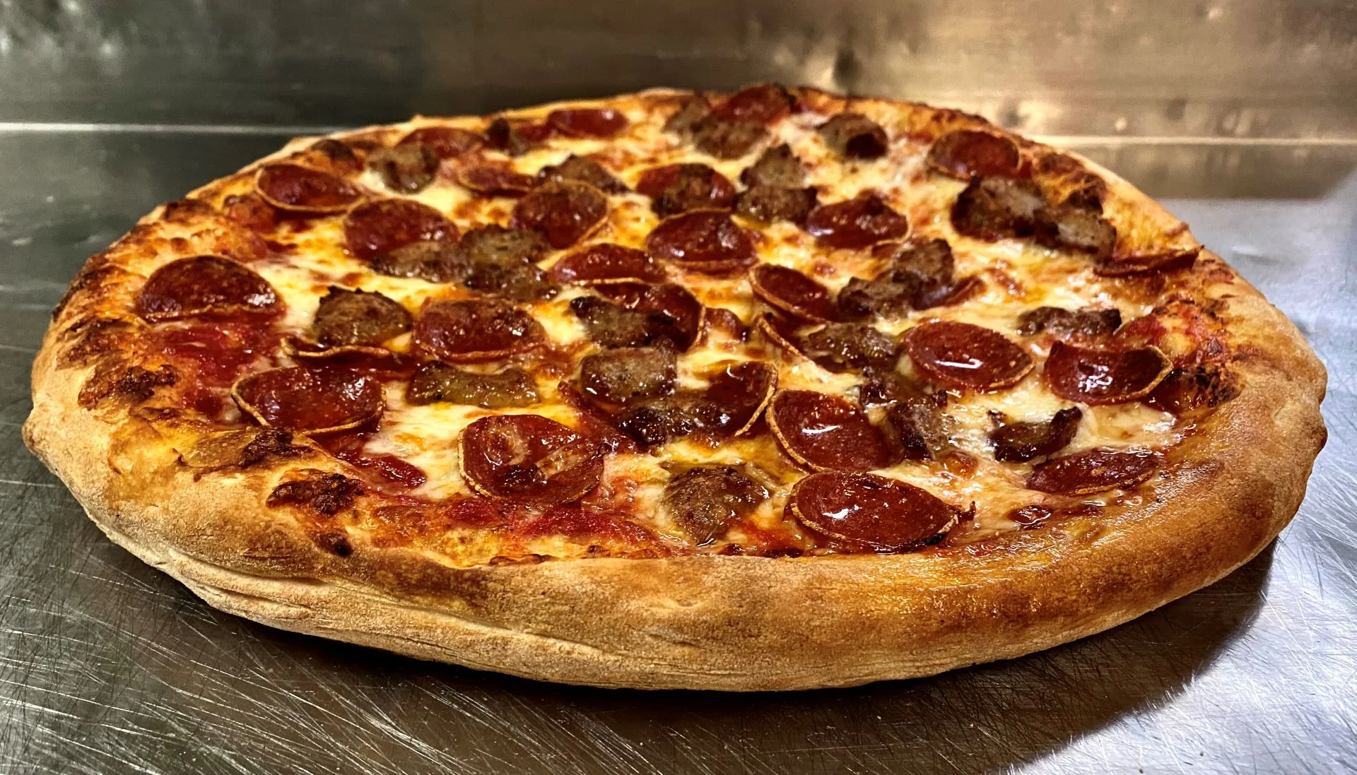 Pepperoni and sausage pizza from a pizzeria