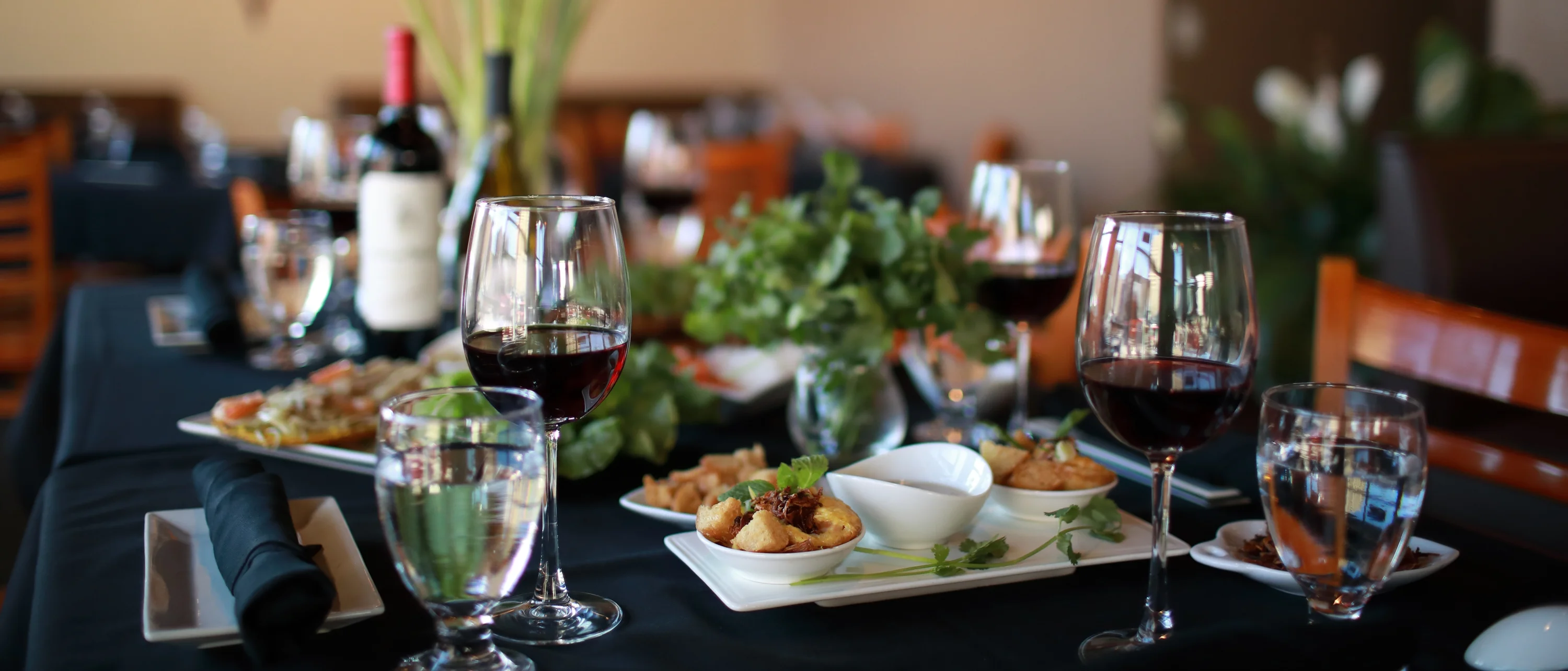 Elegant restaurant table setting with wine and appetizers