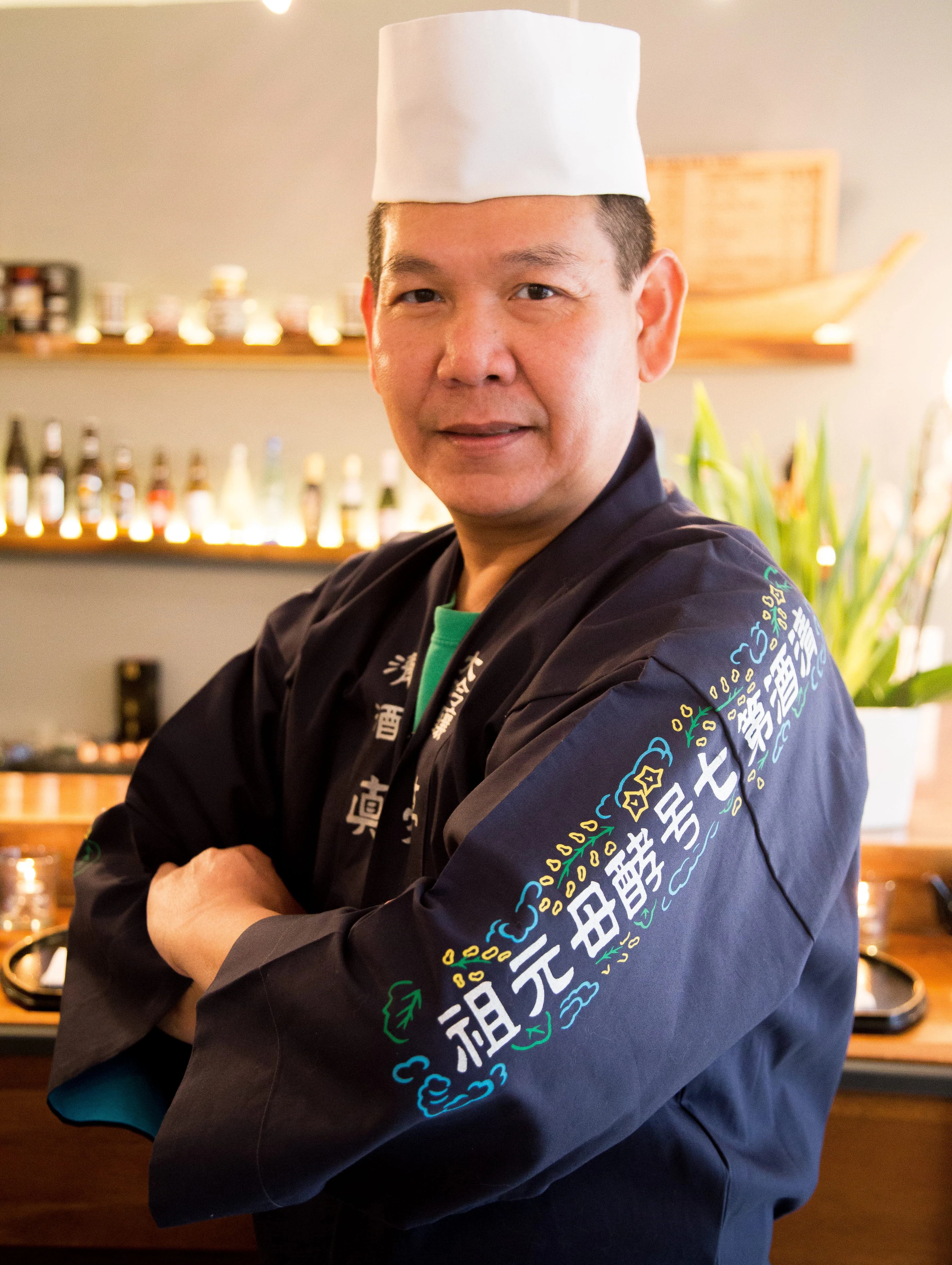Japanese chef in traditional attire at a sushi restaurant
