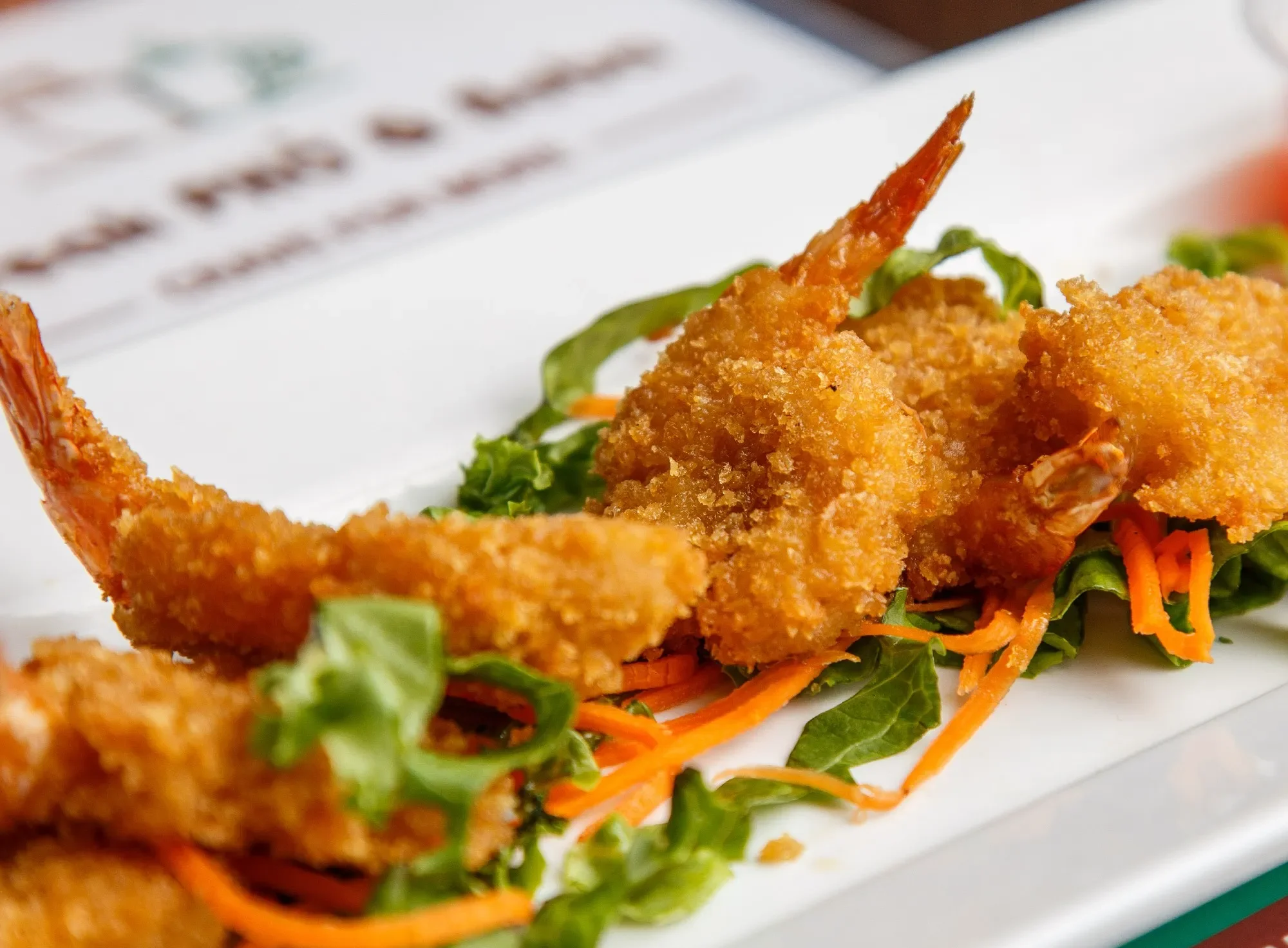 Crispy Vietnamese shrimp spring rolls on a bed of greens