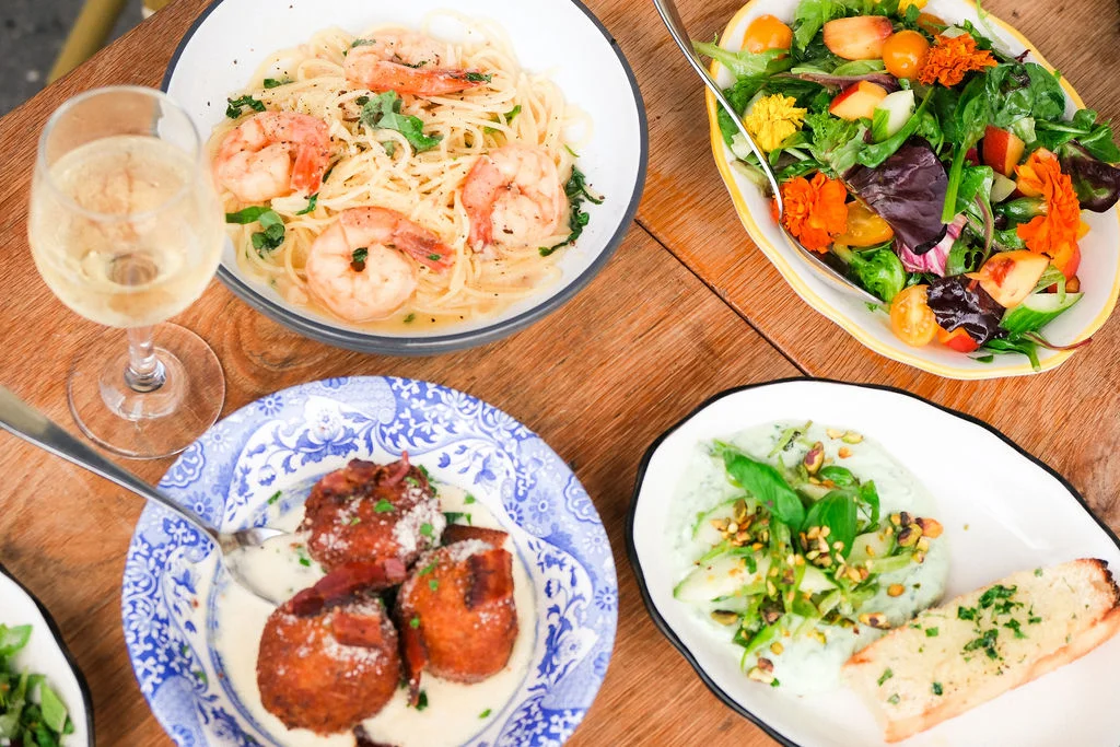 Shrimp linguine with salad and appetizers in a cozy dining setting