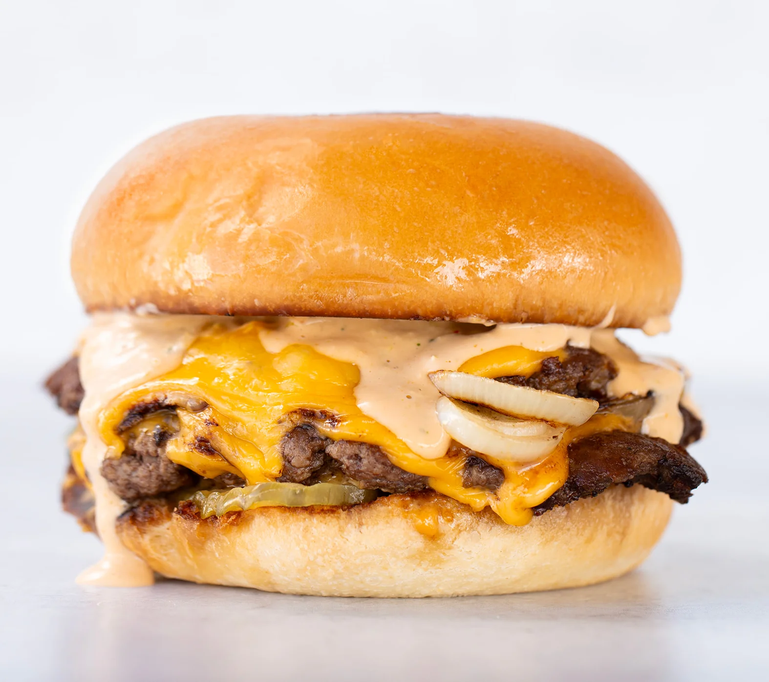Juicy cheeseburger with special sauce and grilled onions