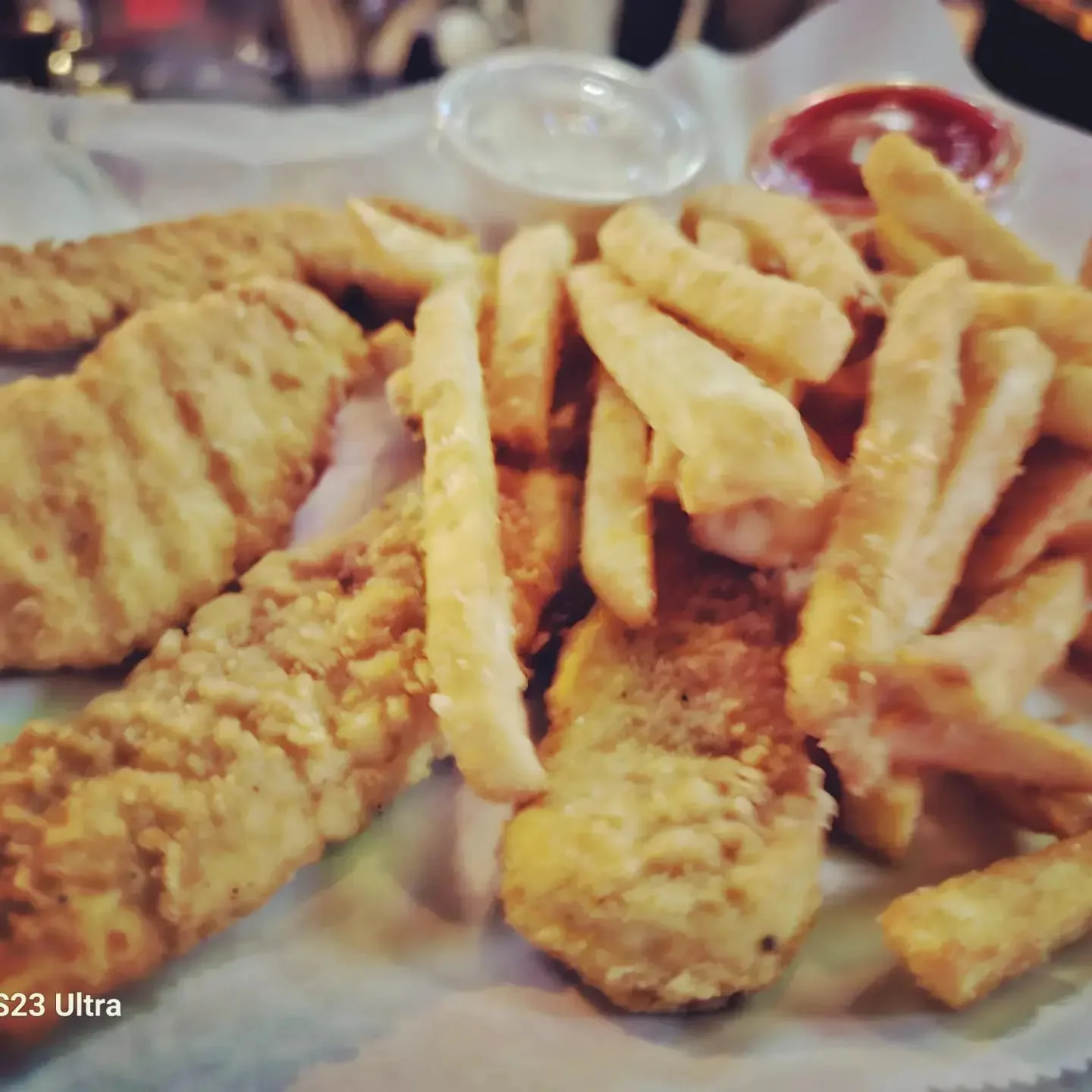 Crispy fried chicken tenders with French fries