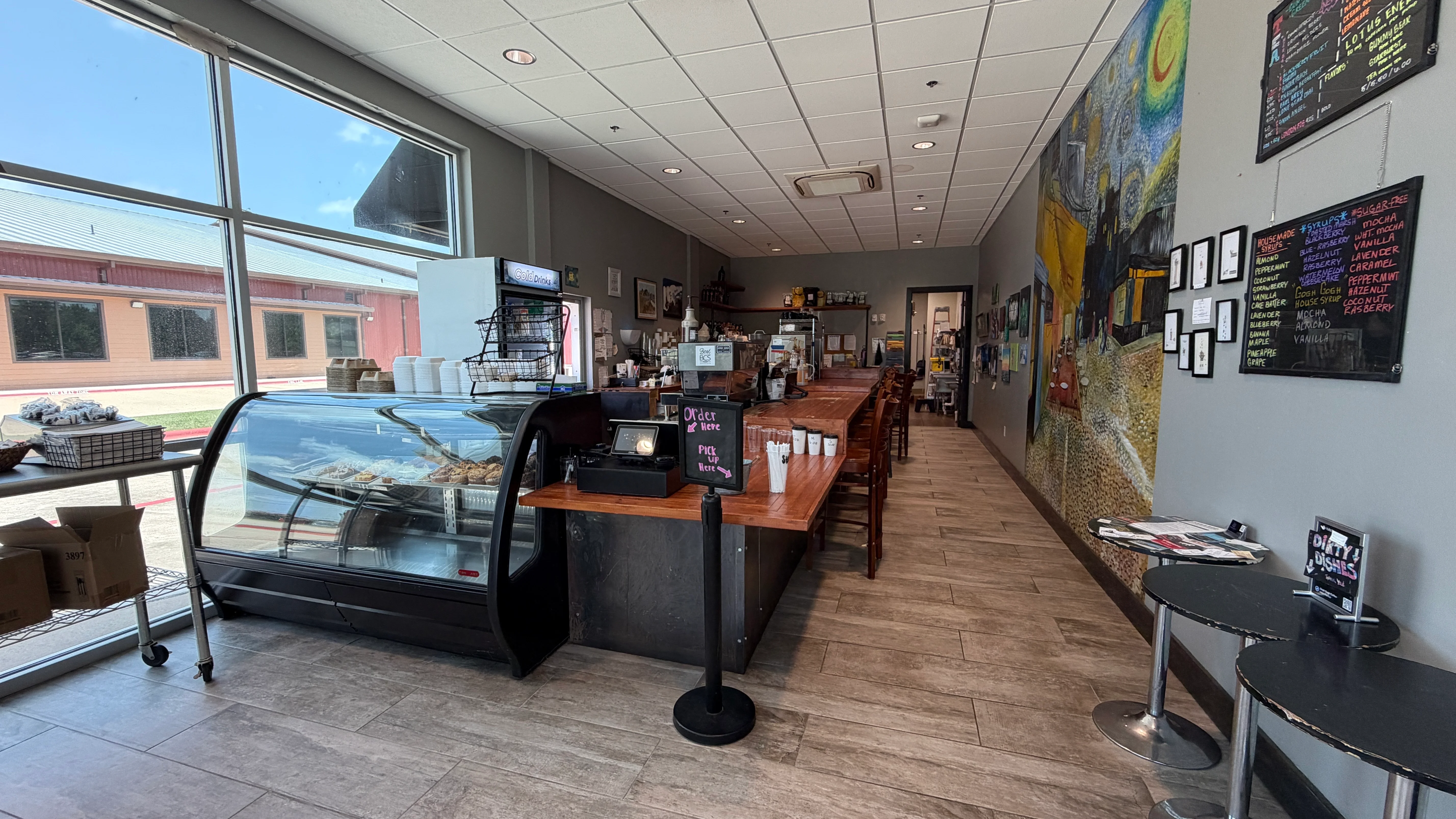 Cozy café interior with wooden counter and vibrant wall art