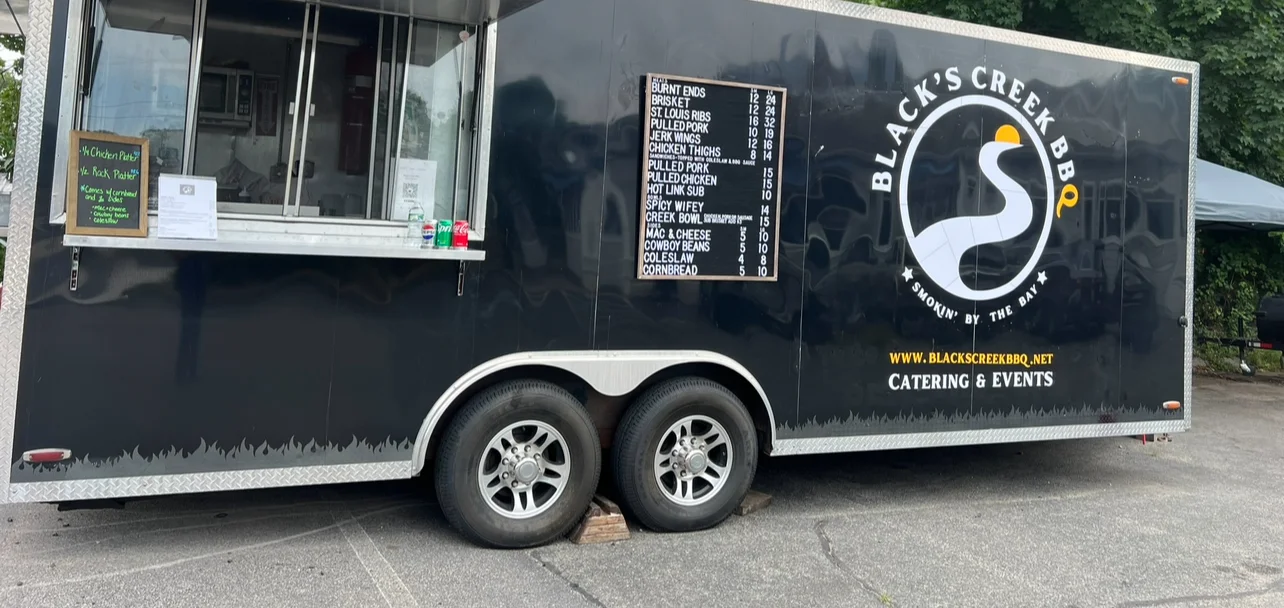 Food truck serving BBQ with menu options