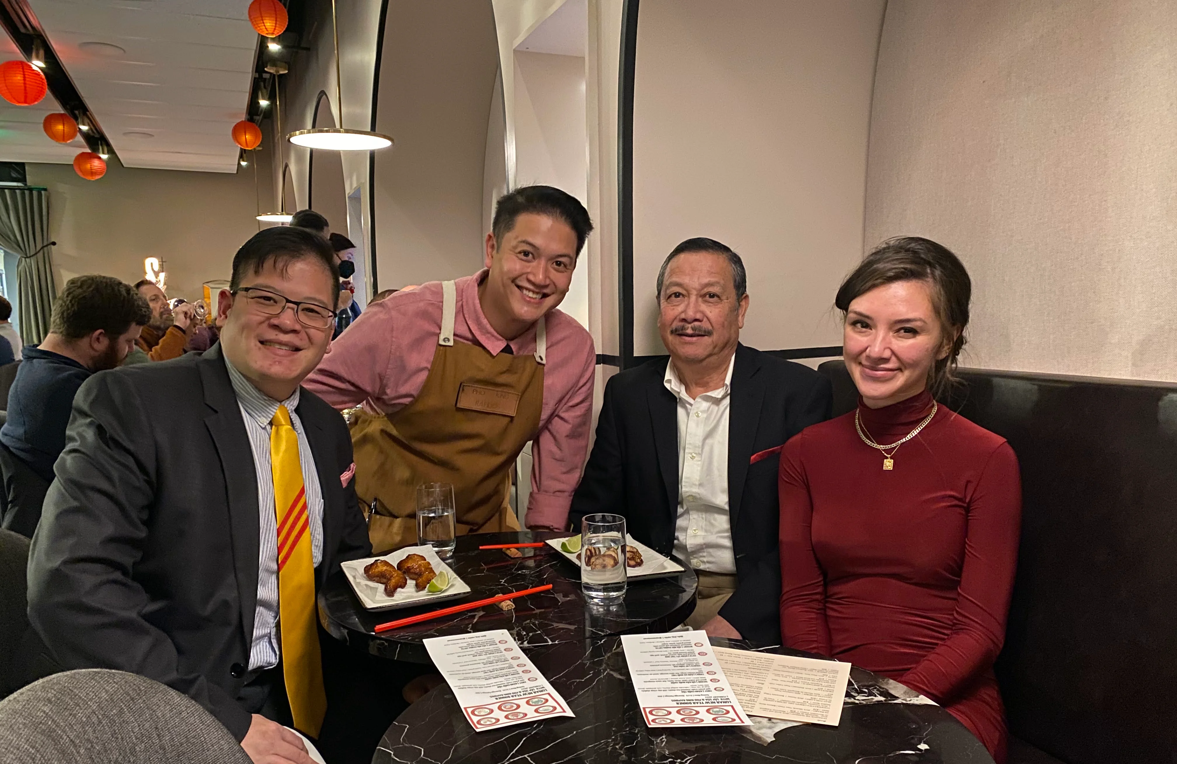 Group enjoying Asian cuisine in a modern restaurant setting