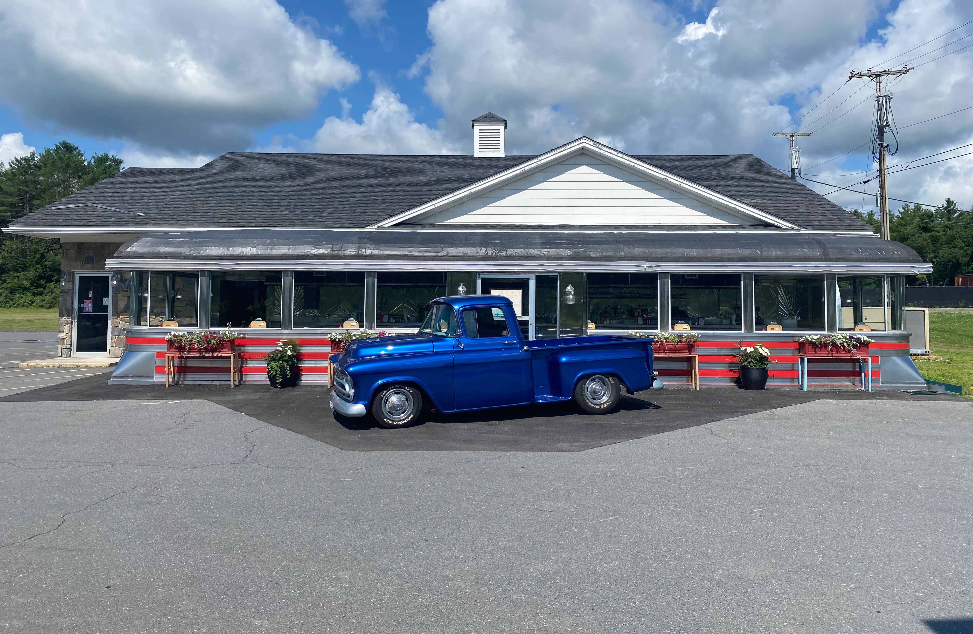 Classic diner exterior with a vintage blue truck