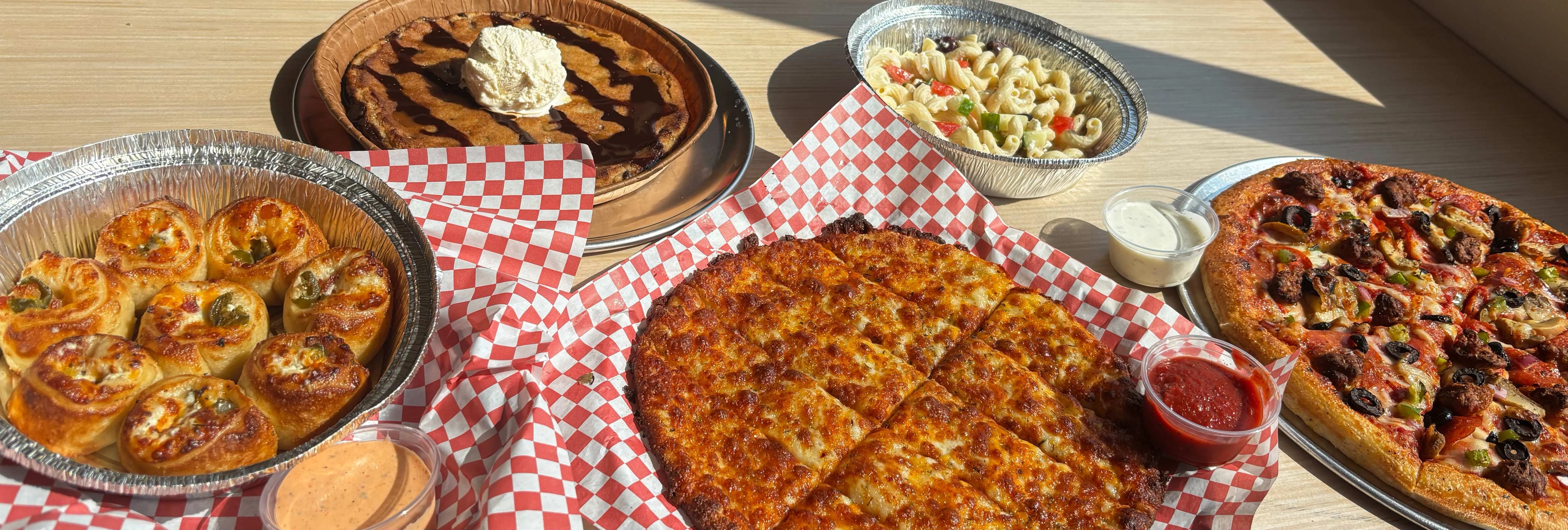 Assorted pizzas and pasta in a casual dining setting