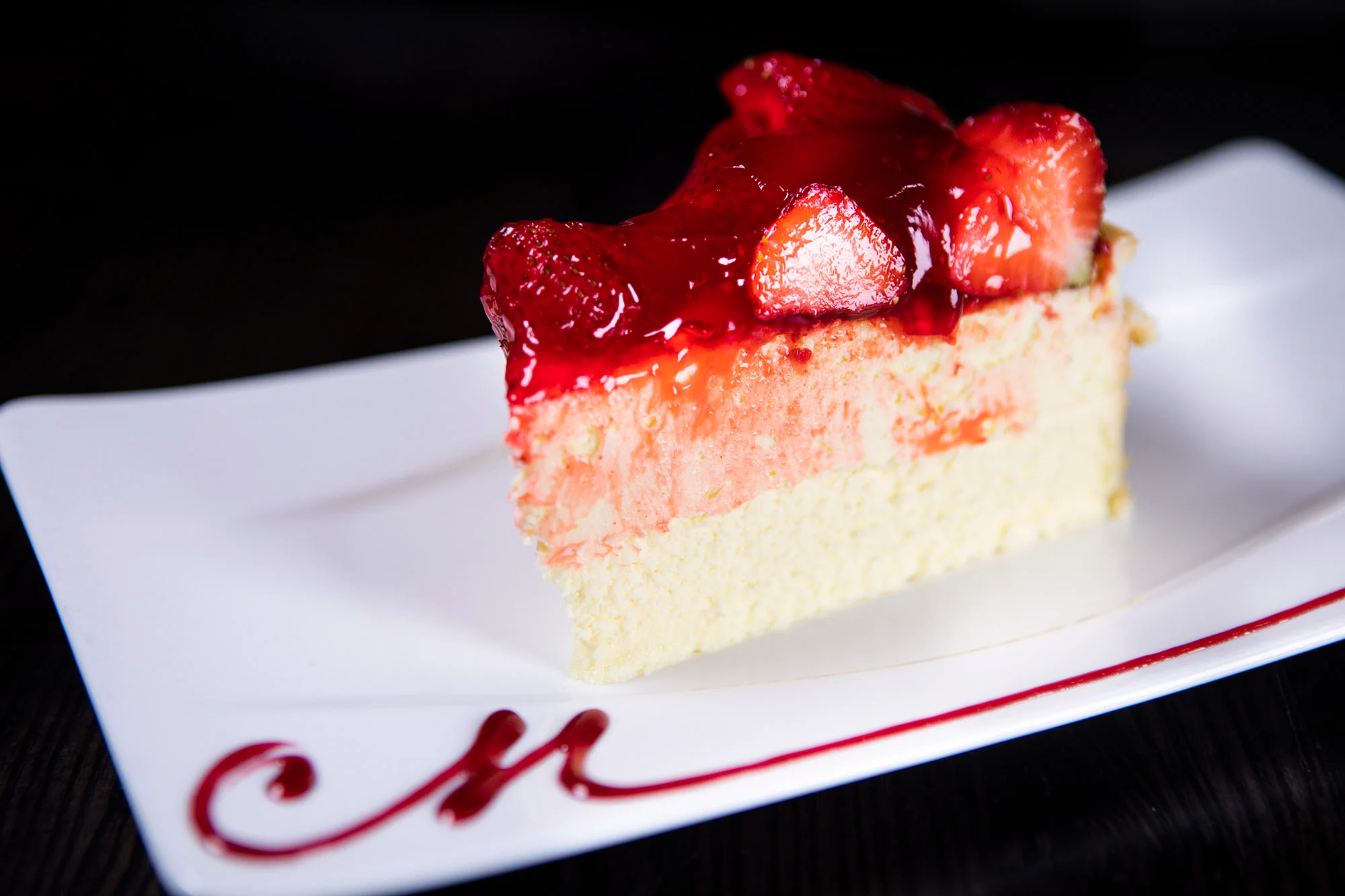 Strawberry cheesecake slice with berry glaze