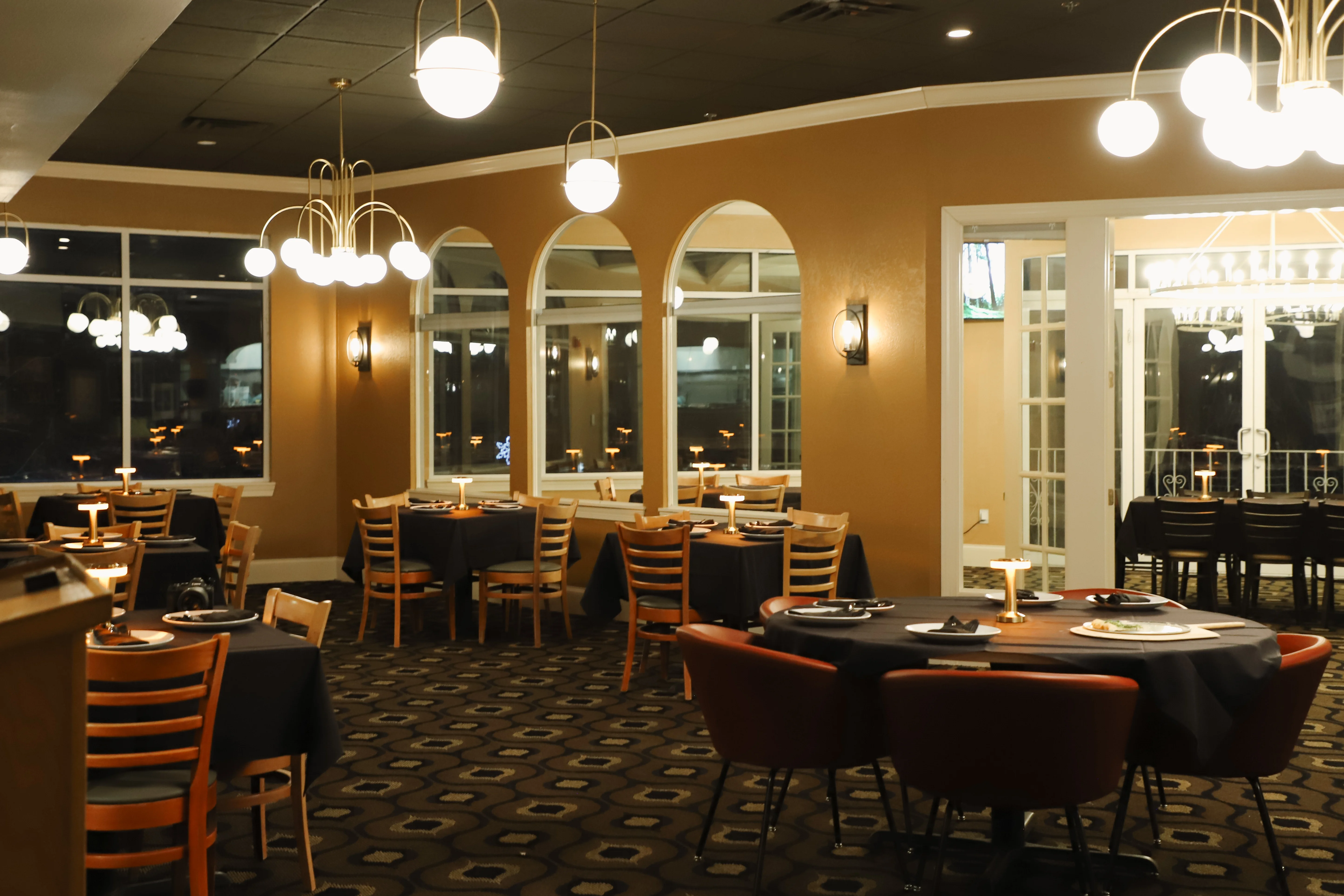 Elegant restaurant interior with warm lighting and cozy seating