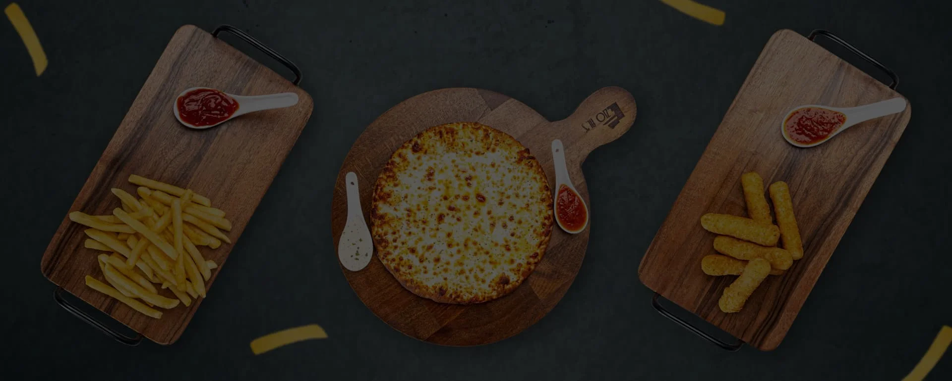 Cheesy pizza with fries and mozzarella sticks on wooden platters