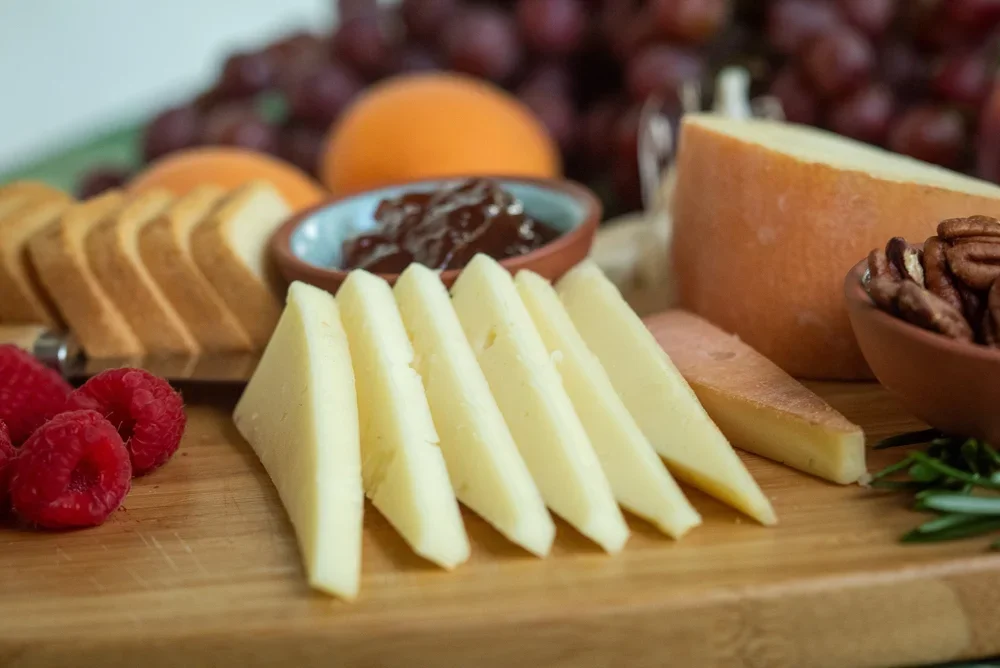 Artisanal cheese platter with fruits and nuts