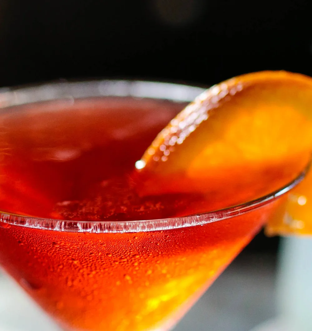 Refreshing cocktail garnished with orange slice