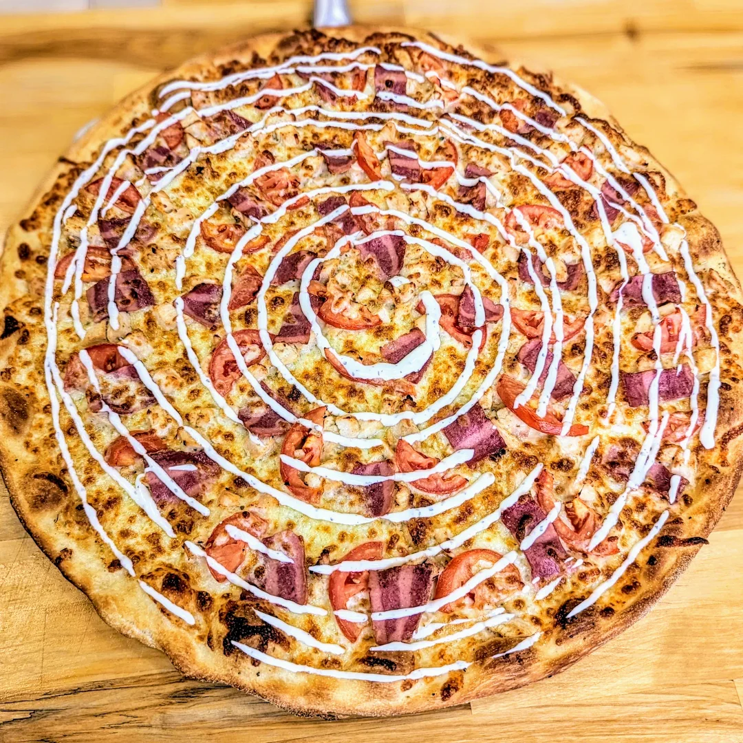 Unique spiral pizza with toppings and sauce