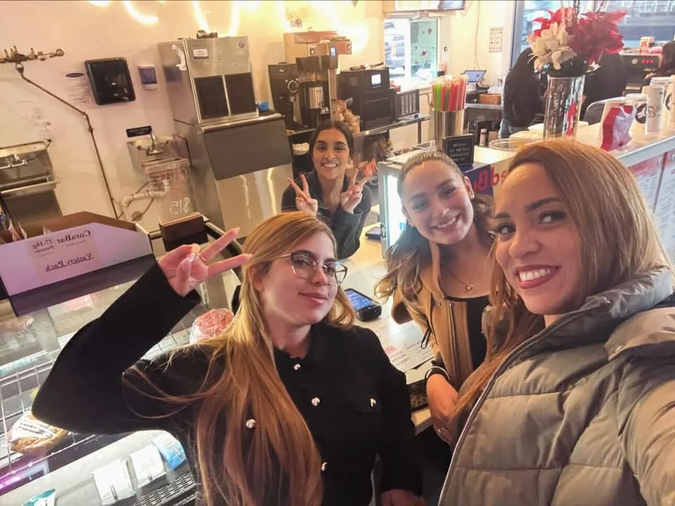 Friendly staff posing in a vibrant restaurant setting