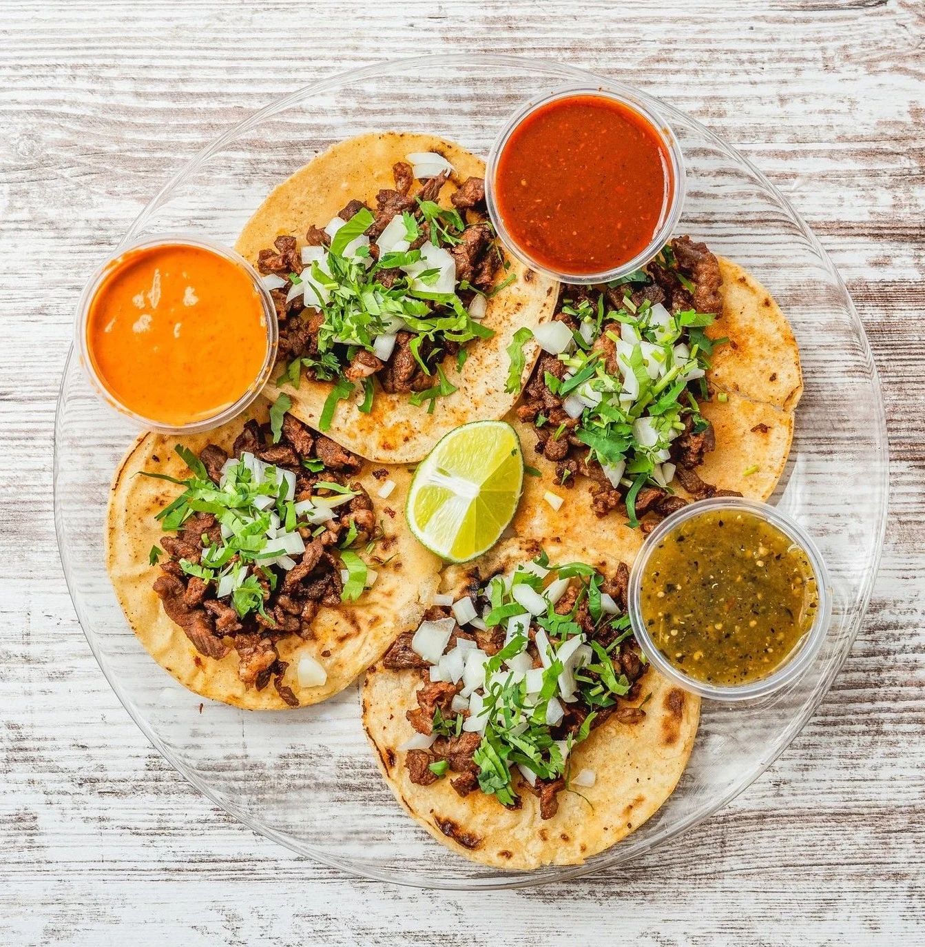 Delicious street tacos with fresh toppings on a wooden table.