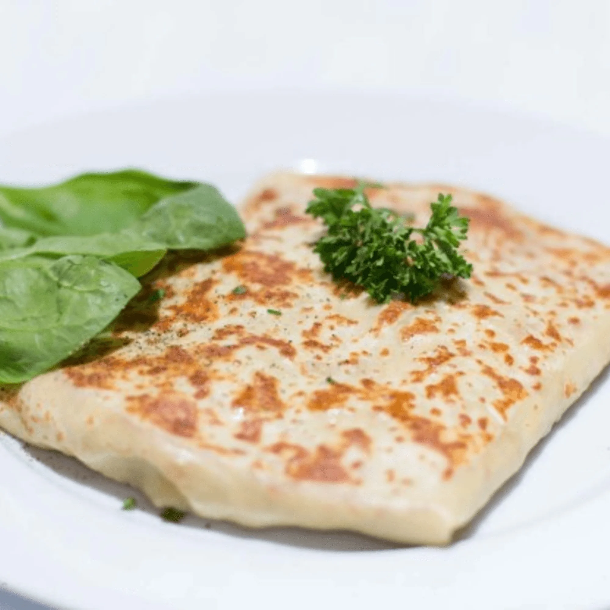 Delicious Indian paratha served with fresh greens