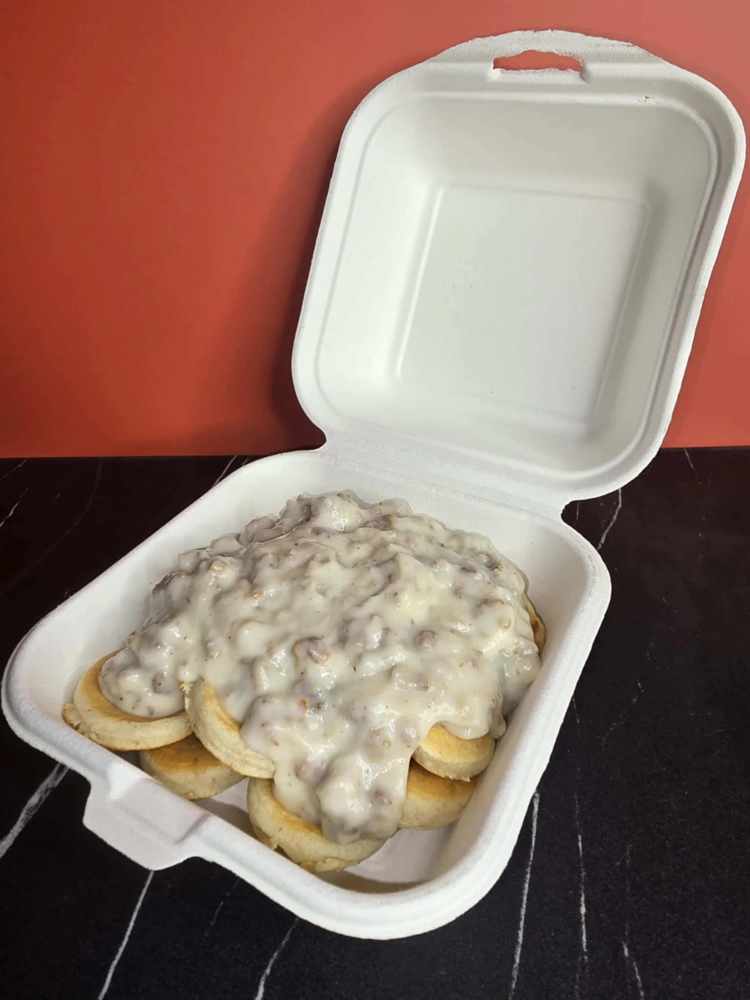 Southern biscuits and gravy in a takeout container