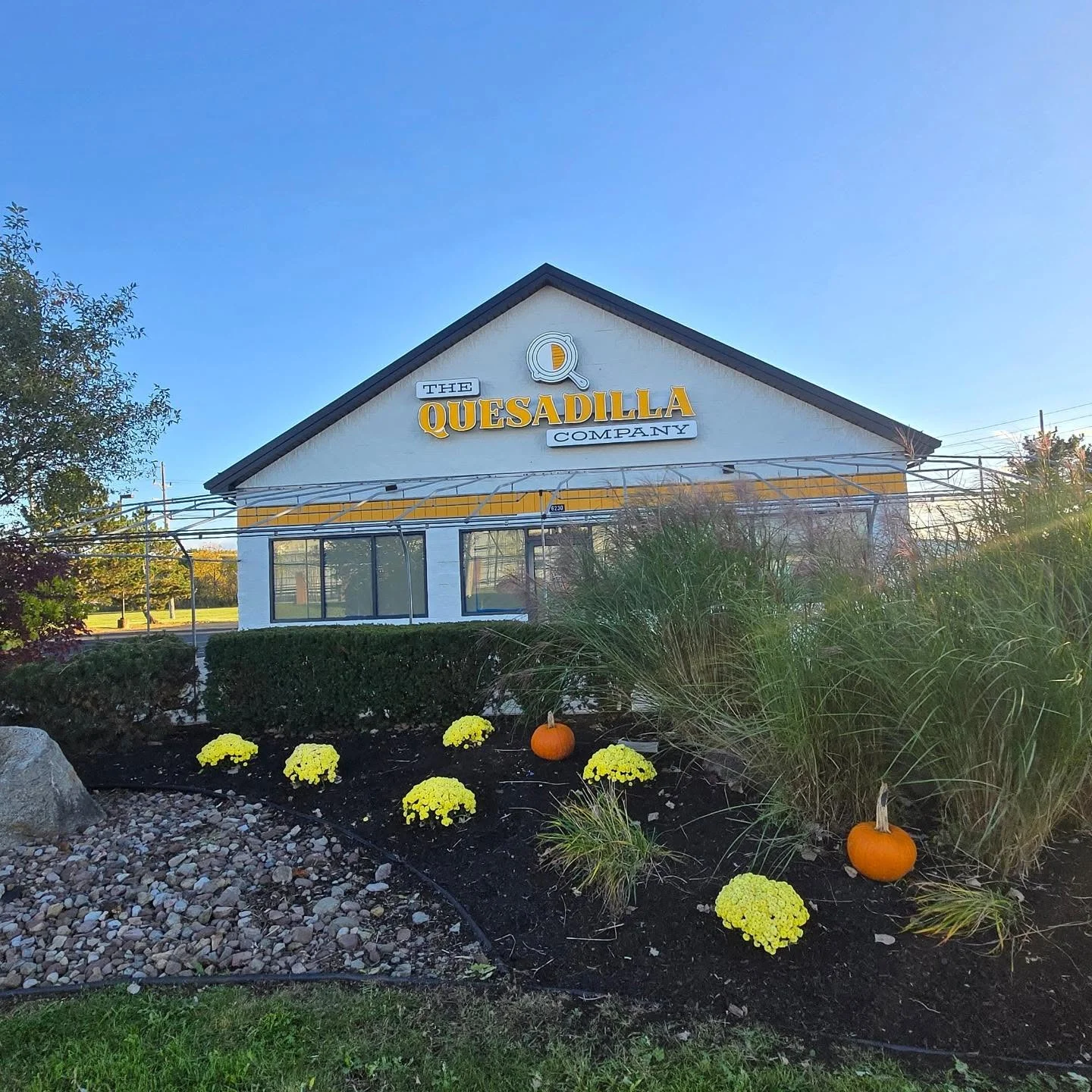 Exterior view of The Quesadilla Company restaurant with seasonal decor