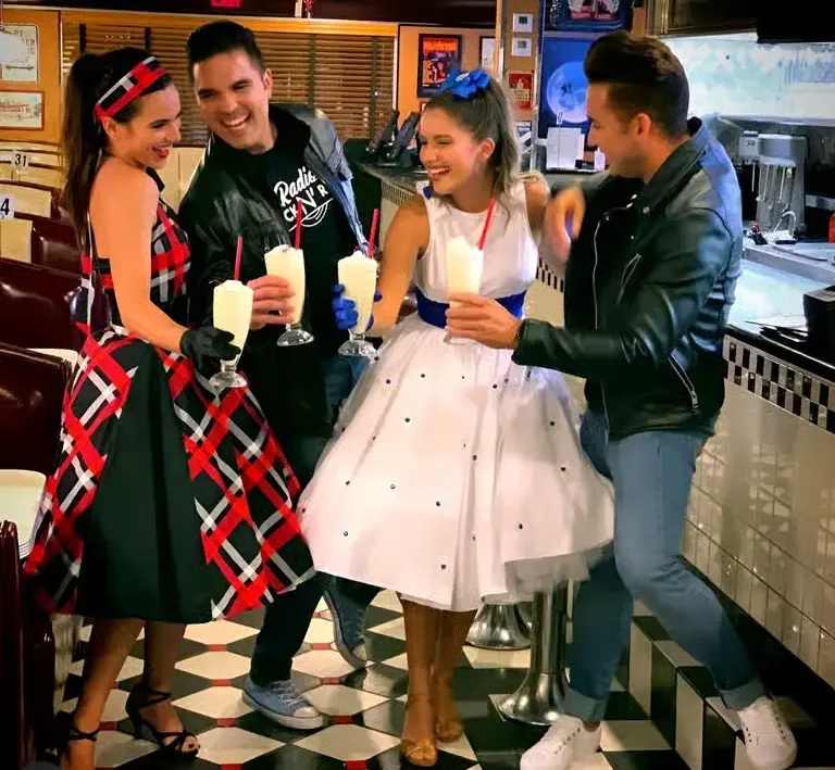 Friends enjoying classic milkshakes and a retro-themed celebration inside Moonlite Diner, showcasing the fun, nostalgic American diner experience.