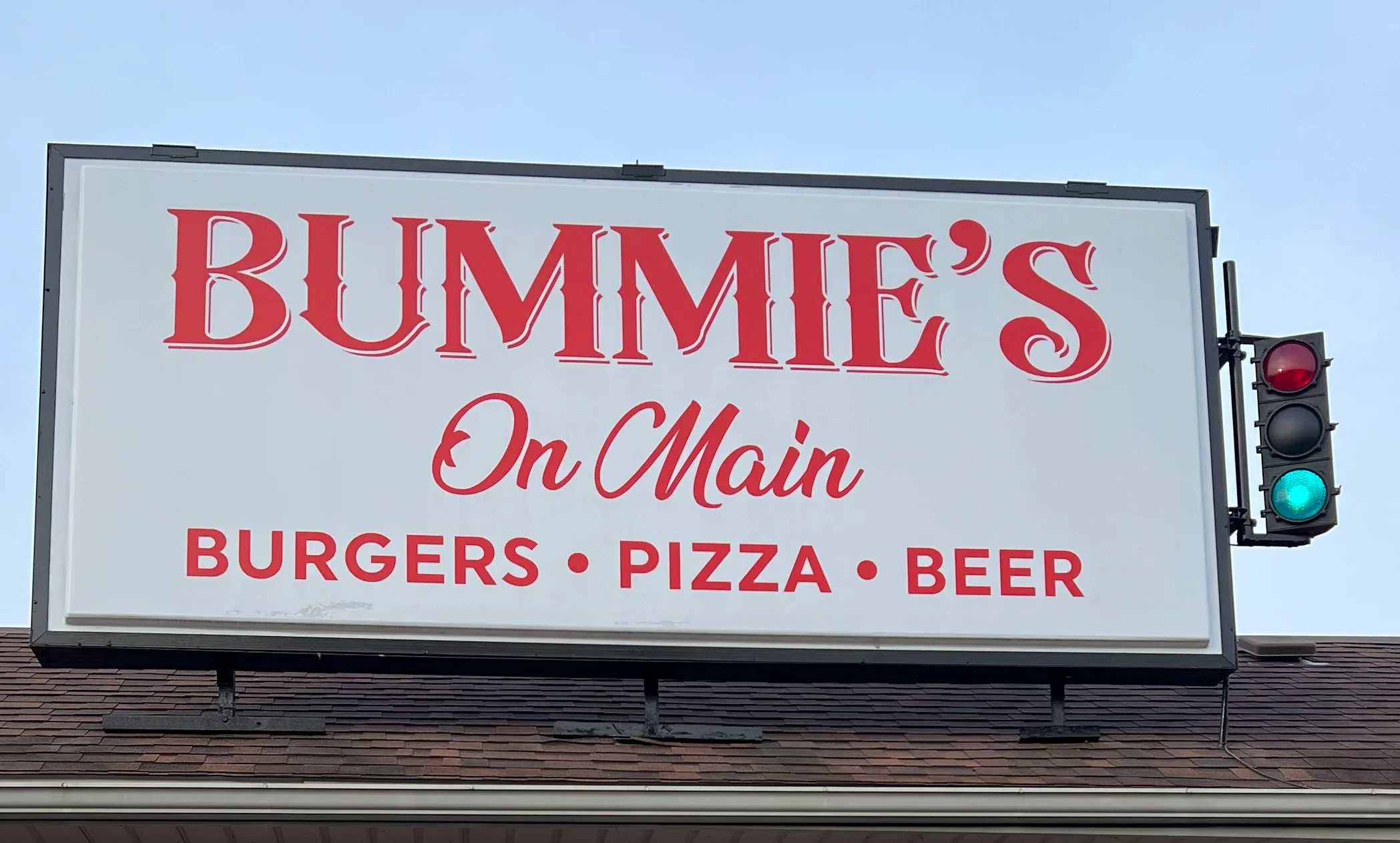 Bummie's On Main restaurant sign featuring burgers, pizza, and beer