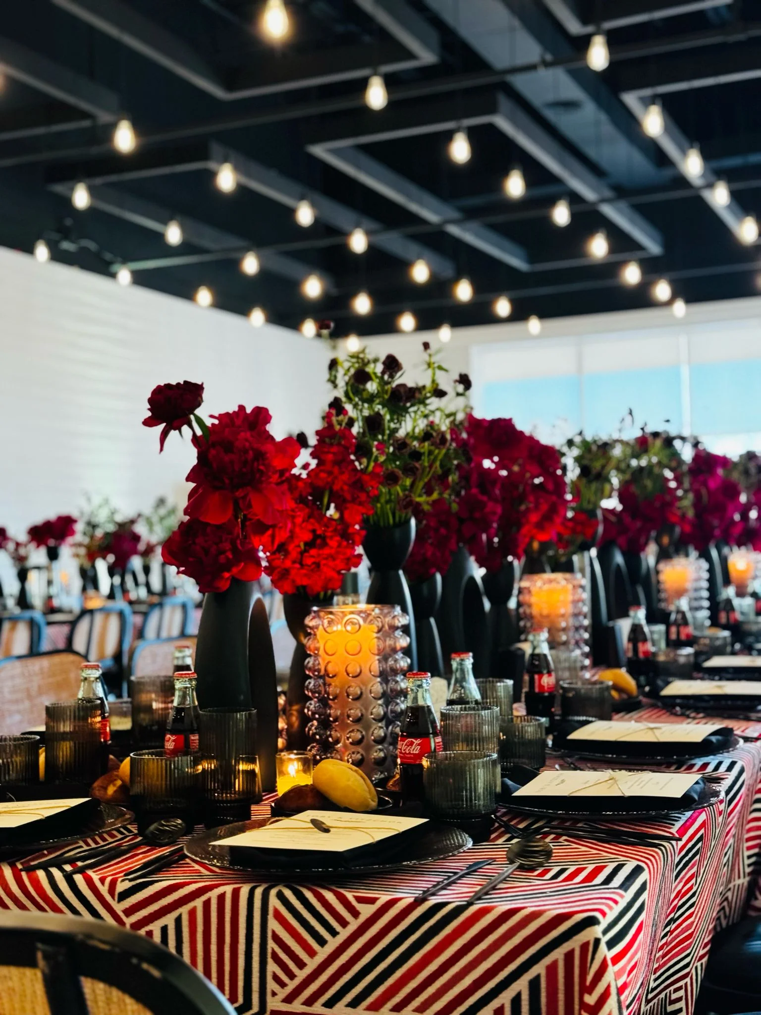 Elegant restaurant dining setup with red floral decor