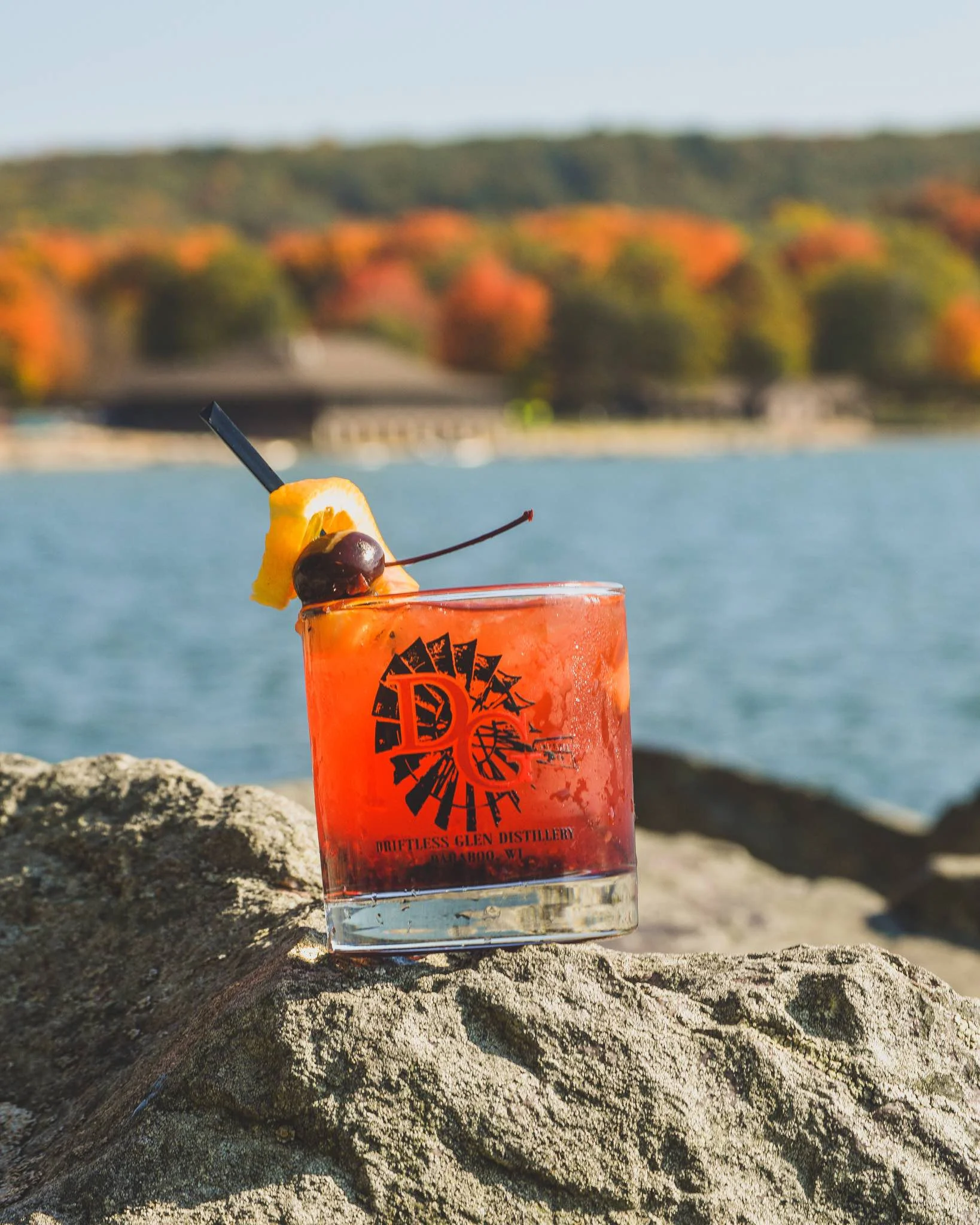 Blackberry Old Fashioned with fall leaves in the background