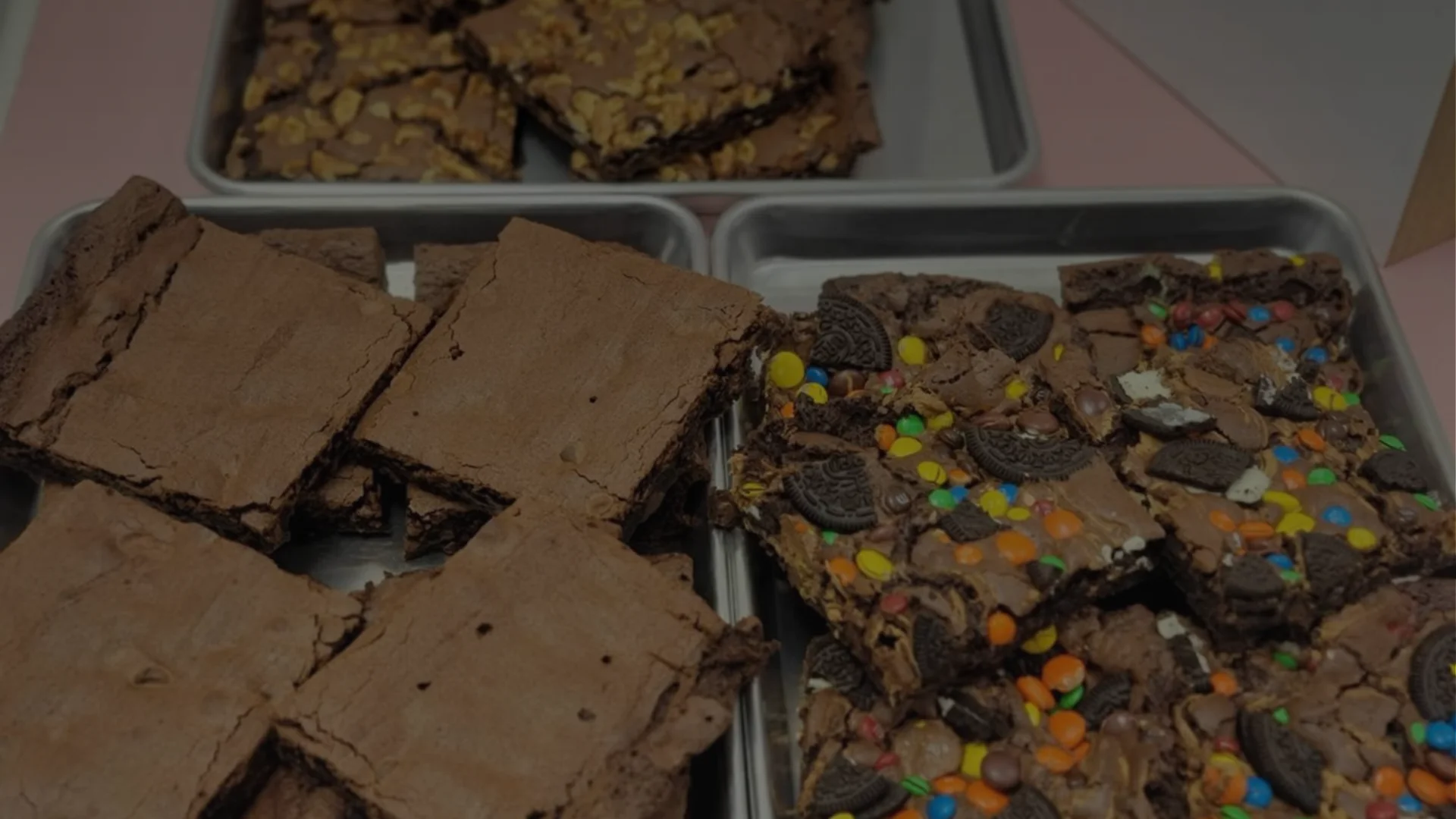 Brownie squares topped with Oreo chunks and colorful M&M candies.