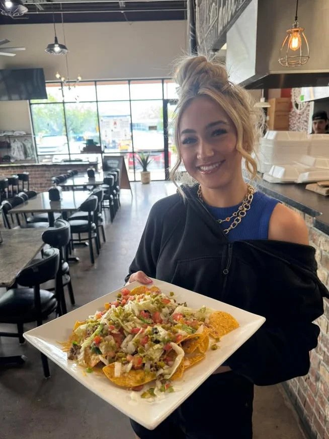 Loaded nachos served in a vibrant restaurant setting