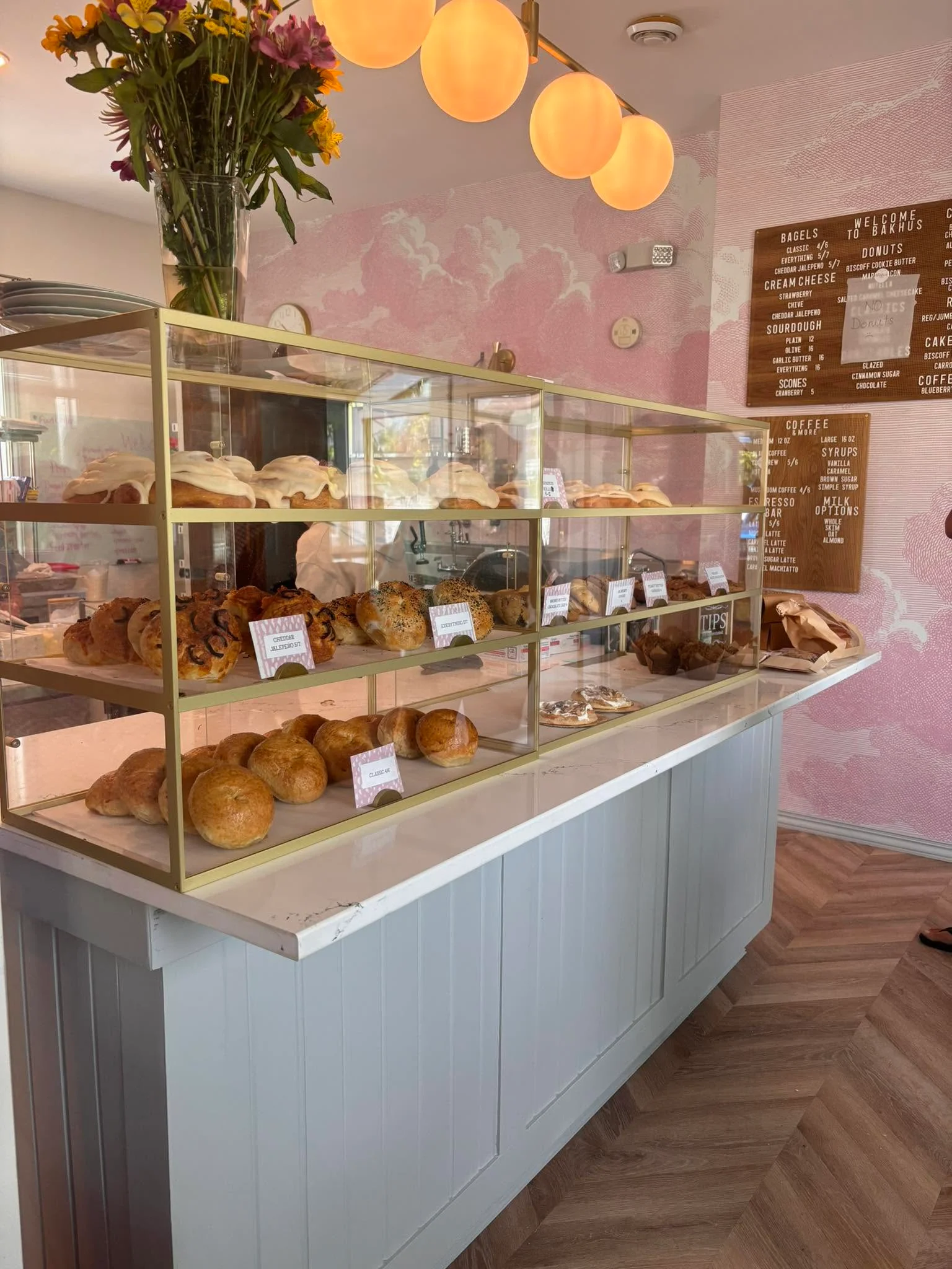 Charming bakery display with fresh pastries and floral decor