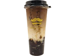 A cup of iced coffee with a layered appearance, featuring cream and boba at the bottom, served in a clear cup.