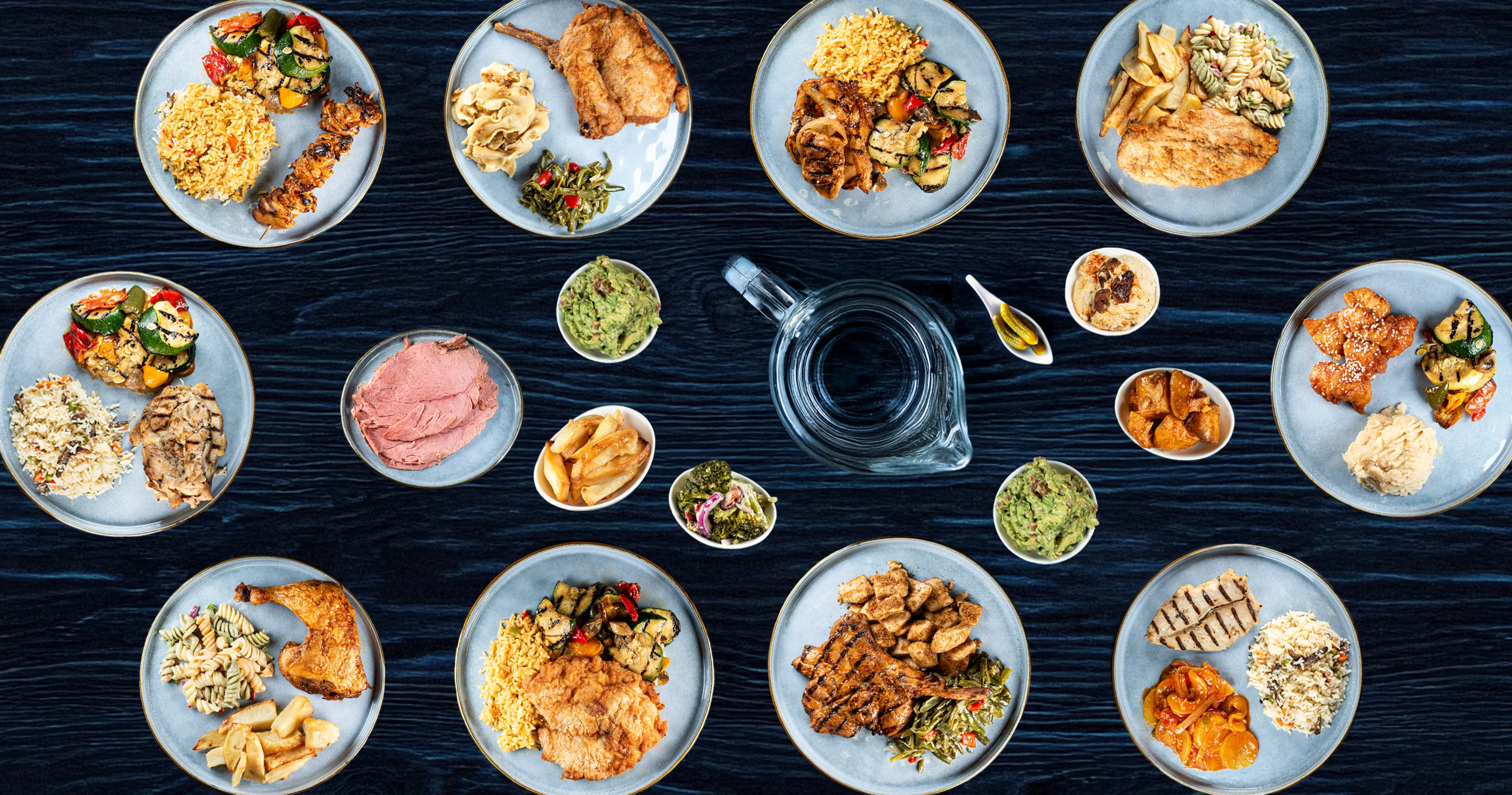 Assorted American comfort food platters with grilled meats and sides