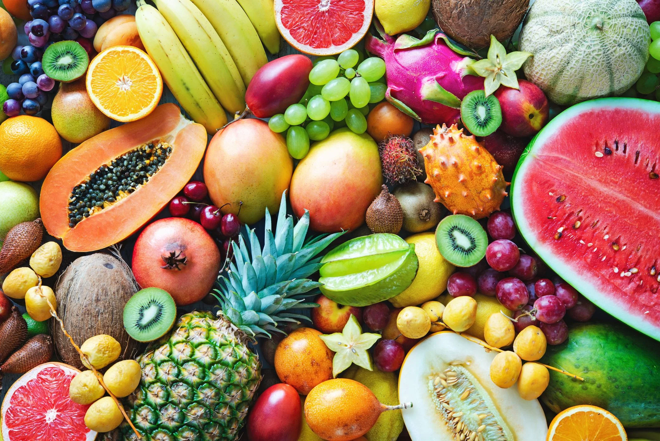 Colorful assortment of tropical fruits on a wooden surface