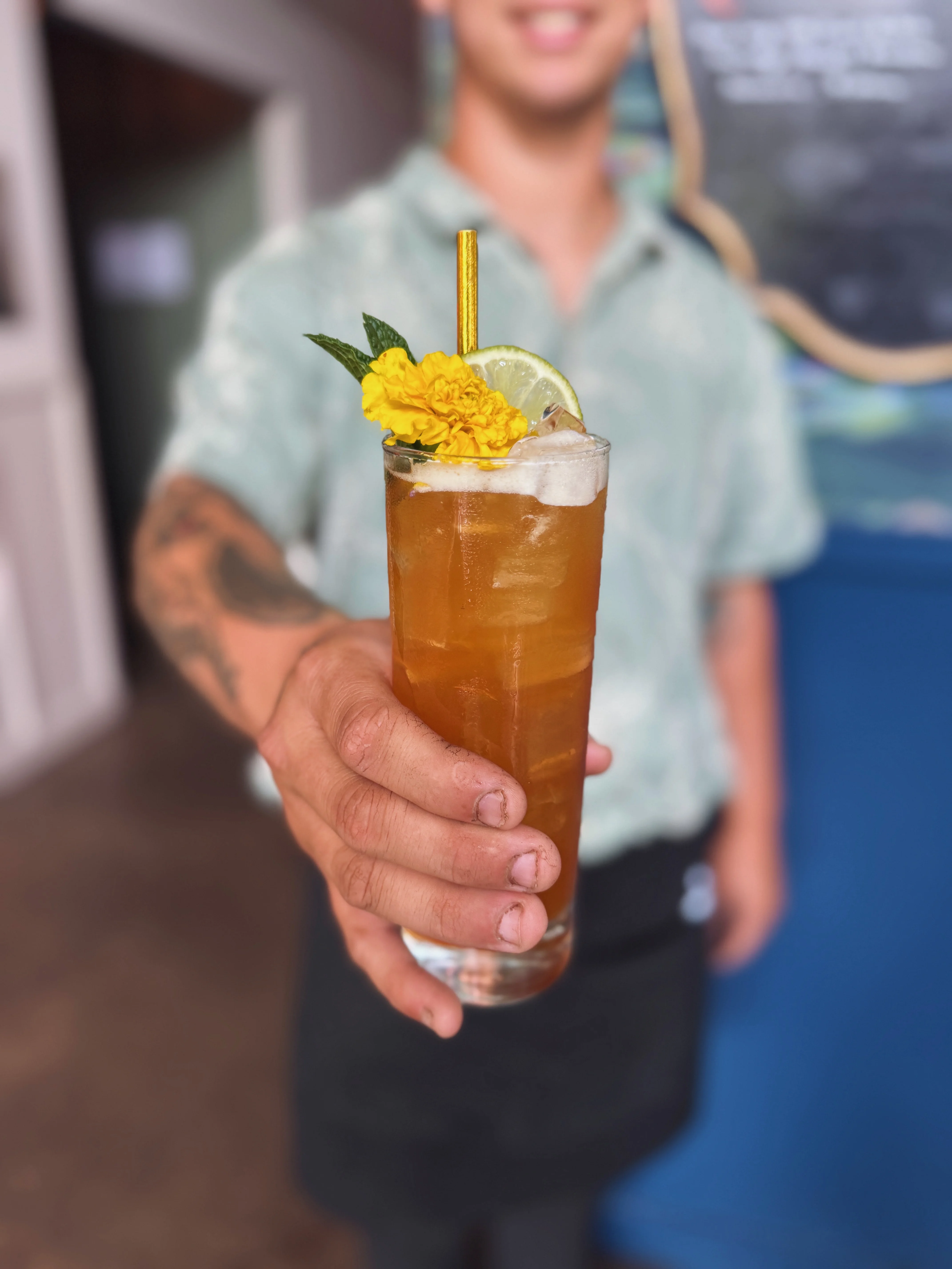 Refreshing cocktail garnished with flowers and lime