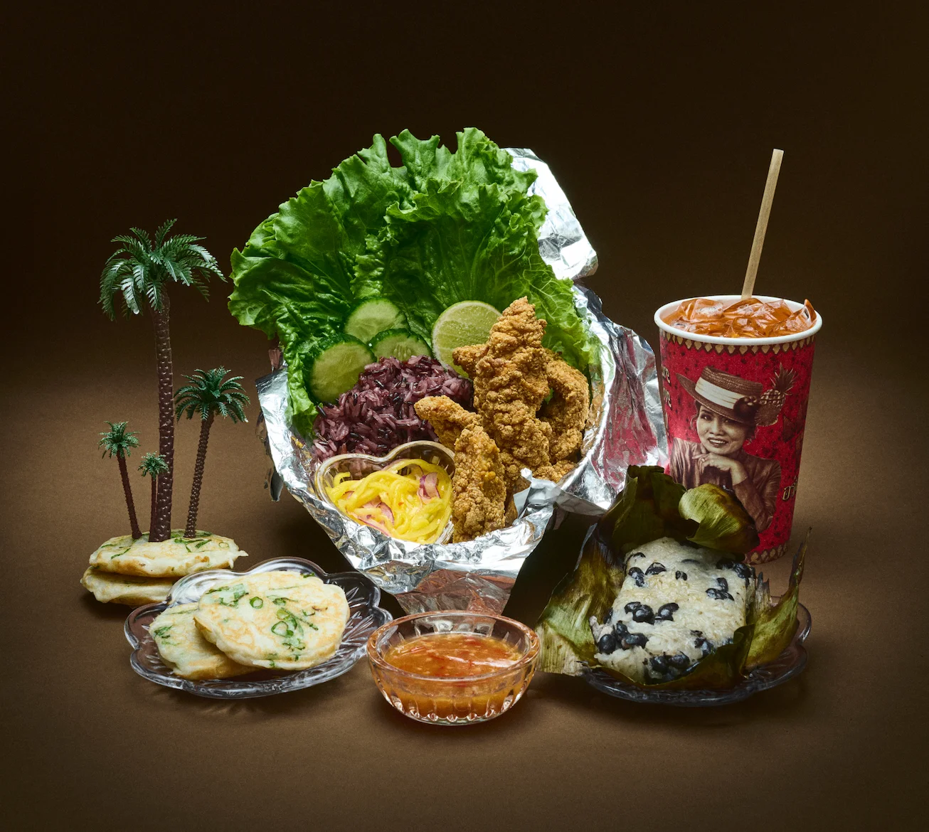 Crispy fried chicken with purple rice and fresh vegetables in a vibrant presentation