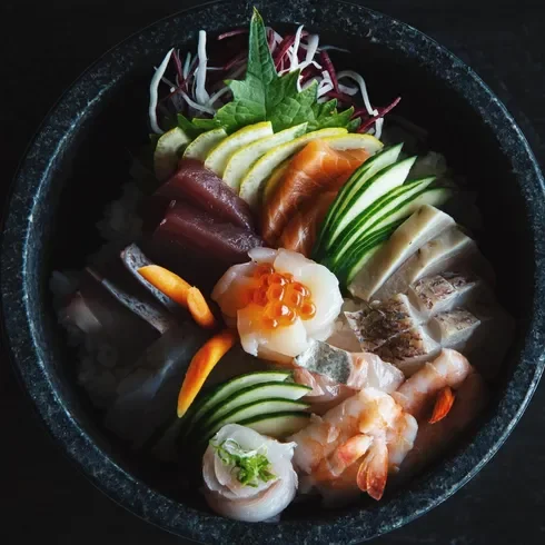Japanese chirashi sushi bowl with assorted sashimi and garnishes