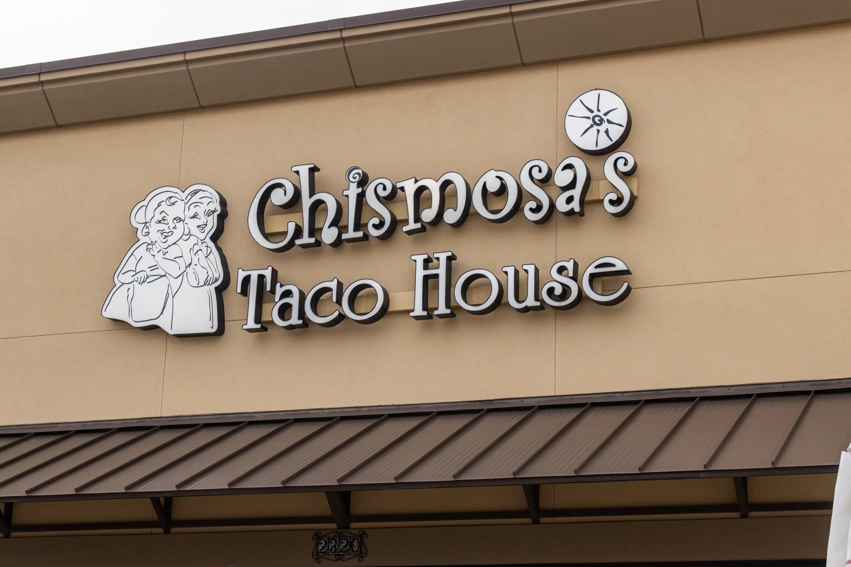 Signage for Chismosa's Taco House featuring playful design