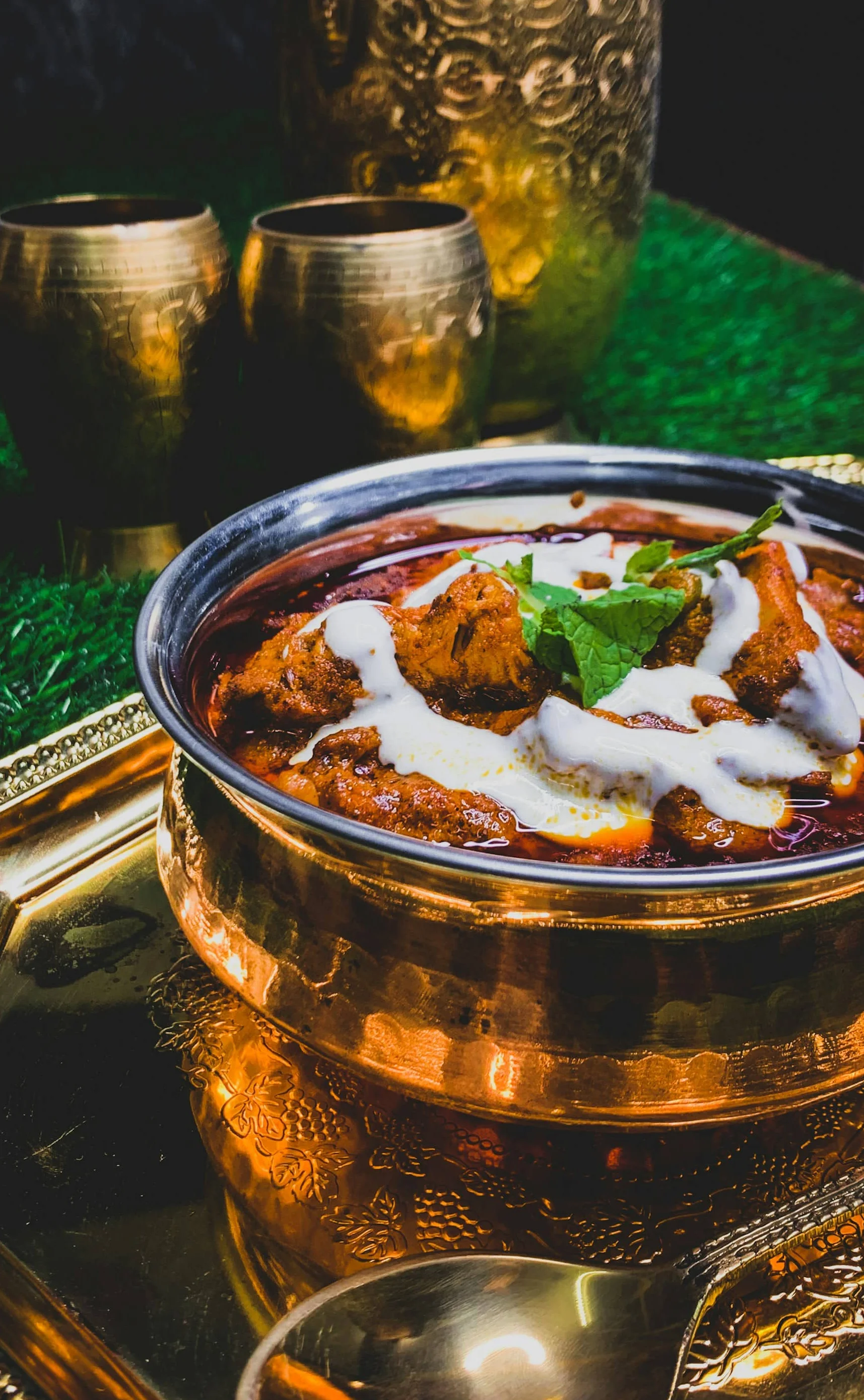Rich Indian butter chicken served in a traditional bowl