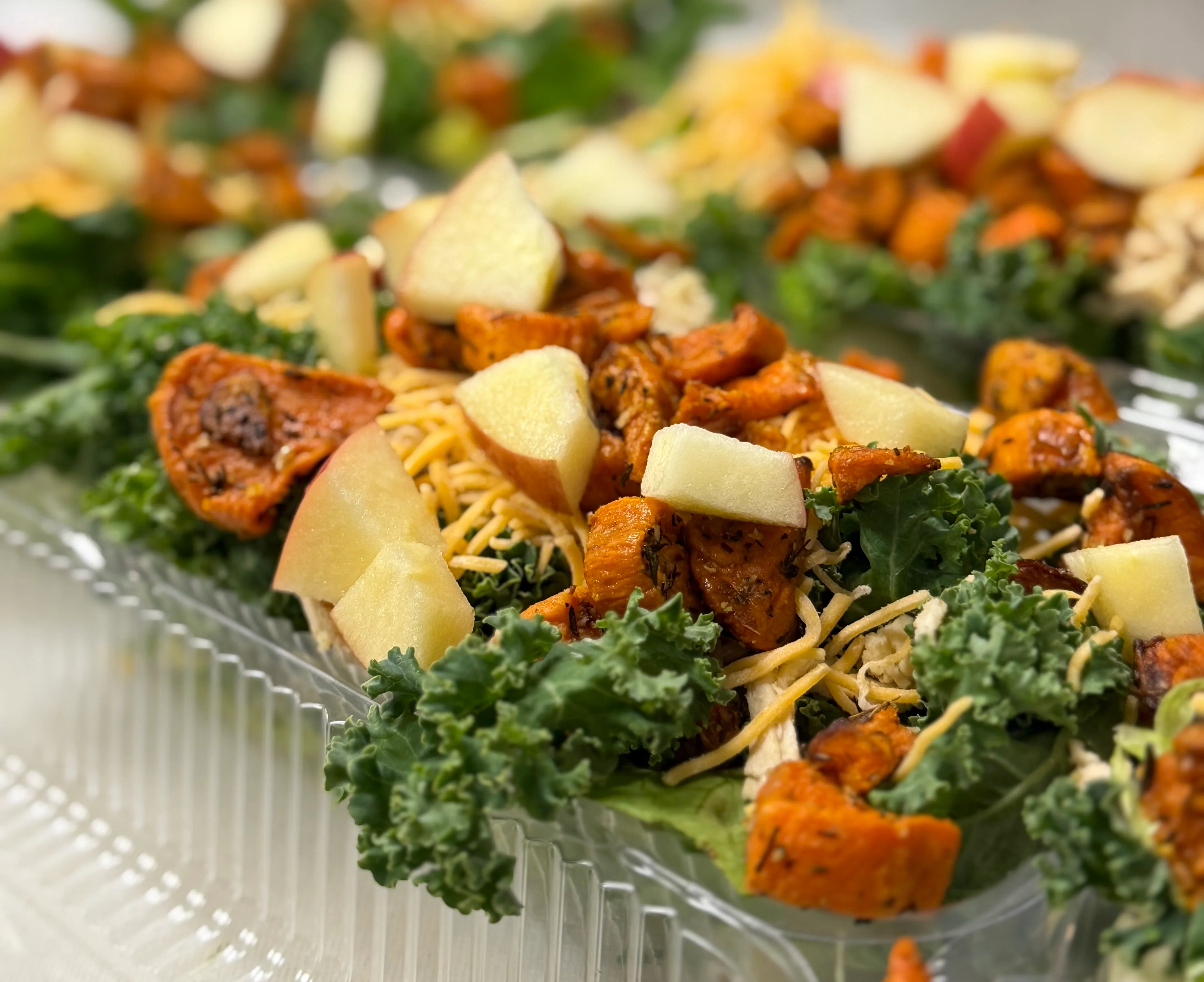 Colorful kale salad with roasted vegetables and apples