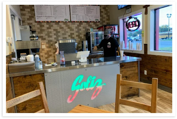 Cozy restaurant interior with a modern counter and menu board