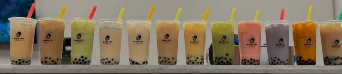 Colorful selection of bubble tea drinks lined up on a counter