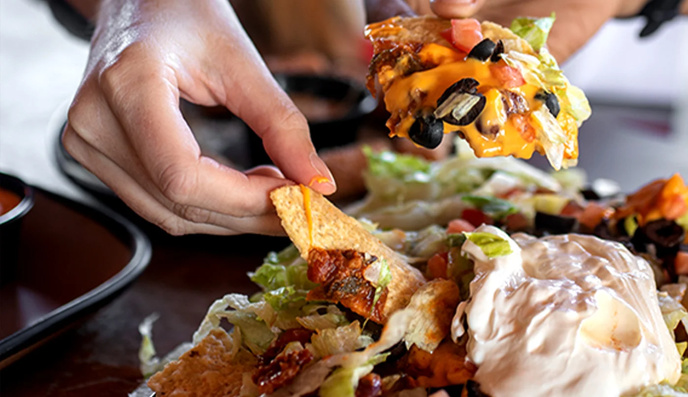 Loaded nachos with cheese and toppings, a popular Mexican dish
