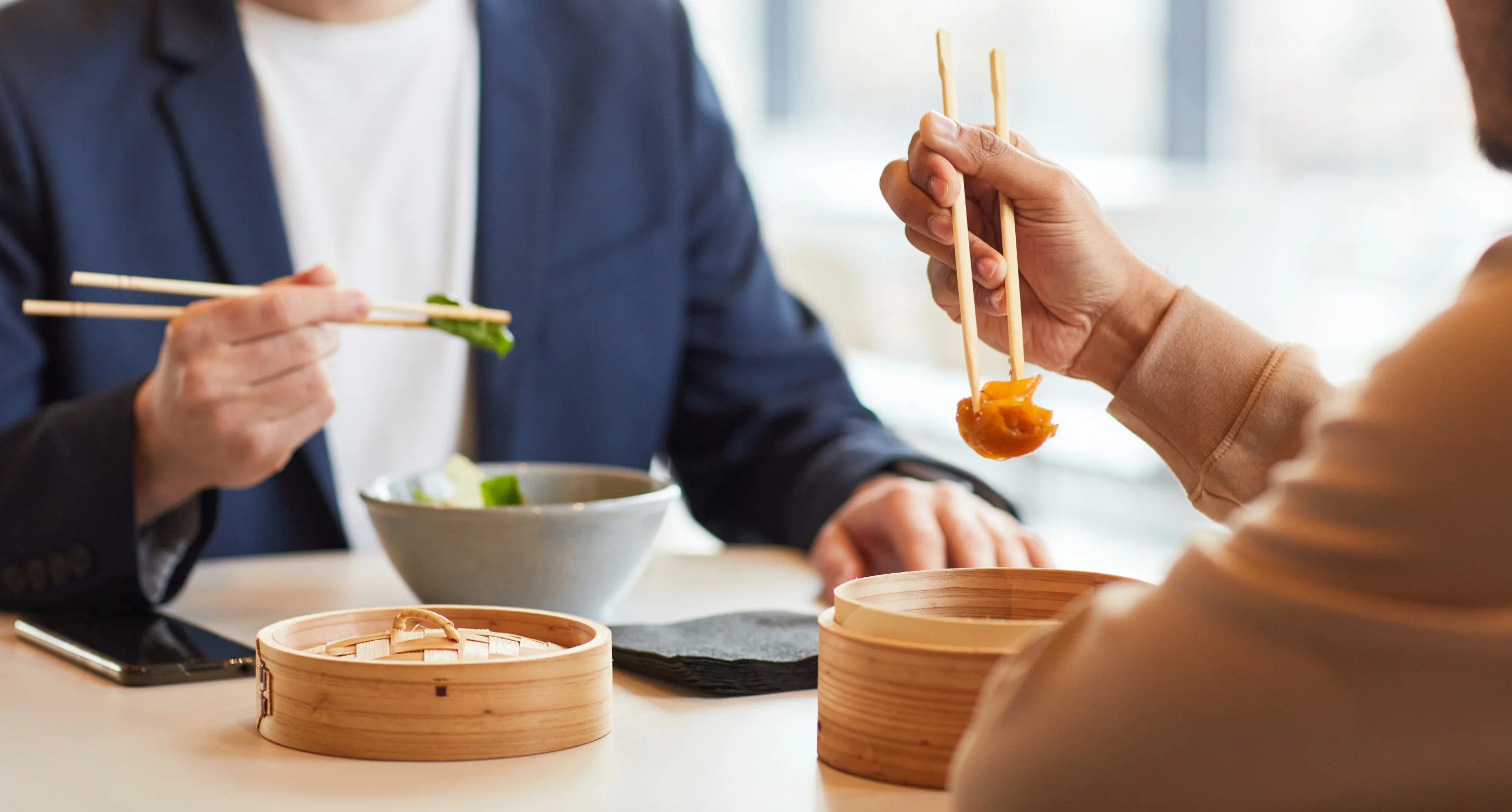 Enjoying dim sum with chopsticks at a modern restaurant